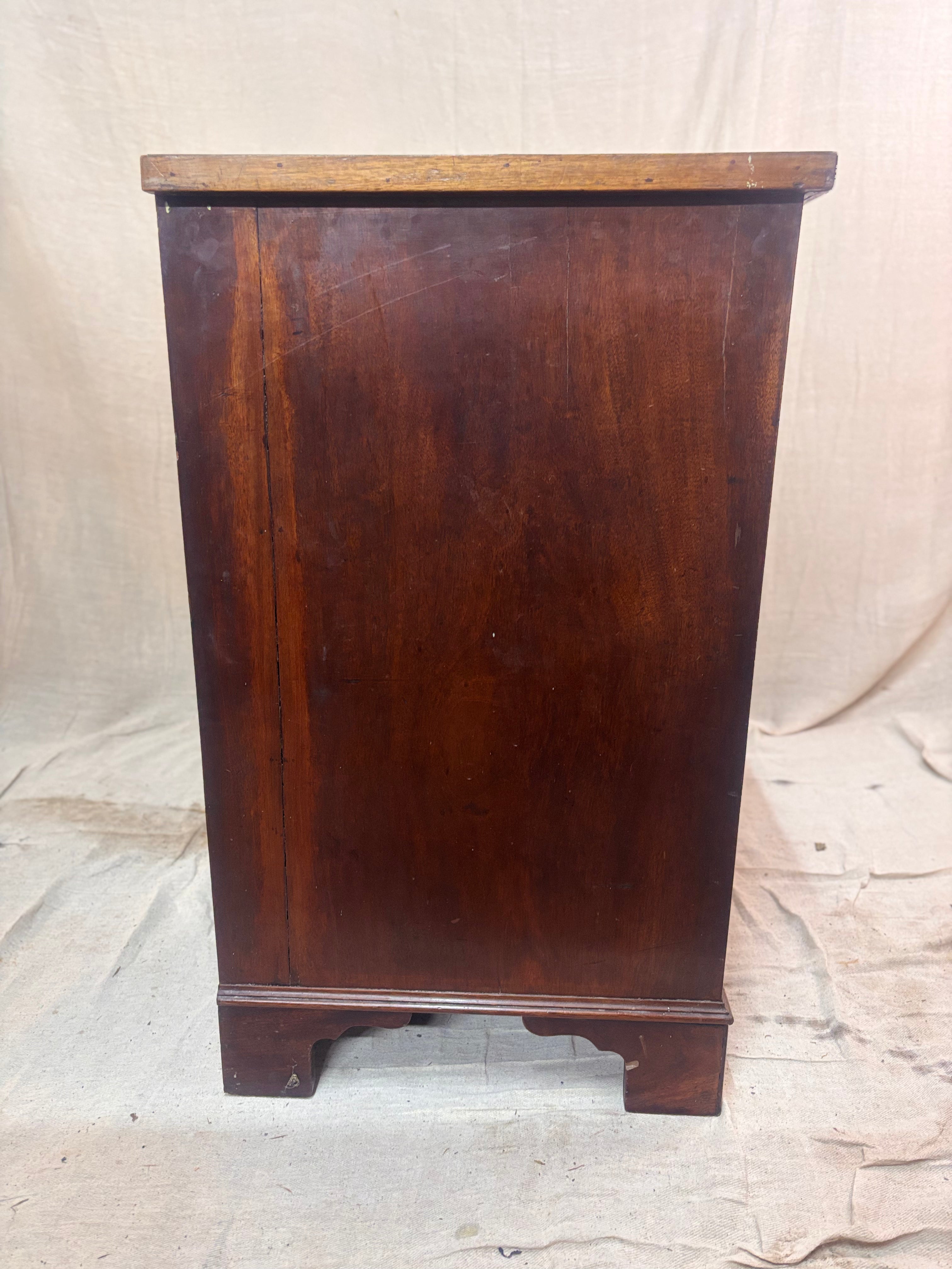 Wooden cabinet with a dark brown finish on a light background