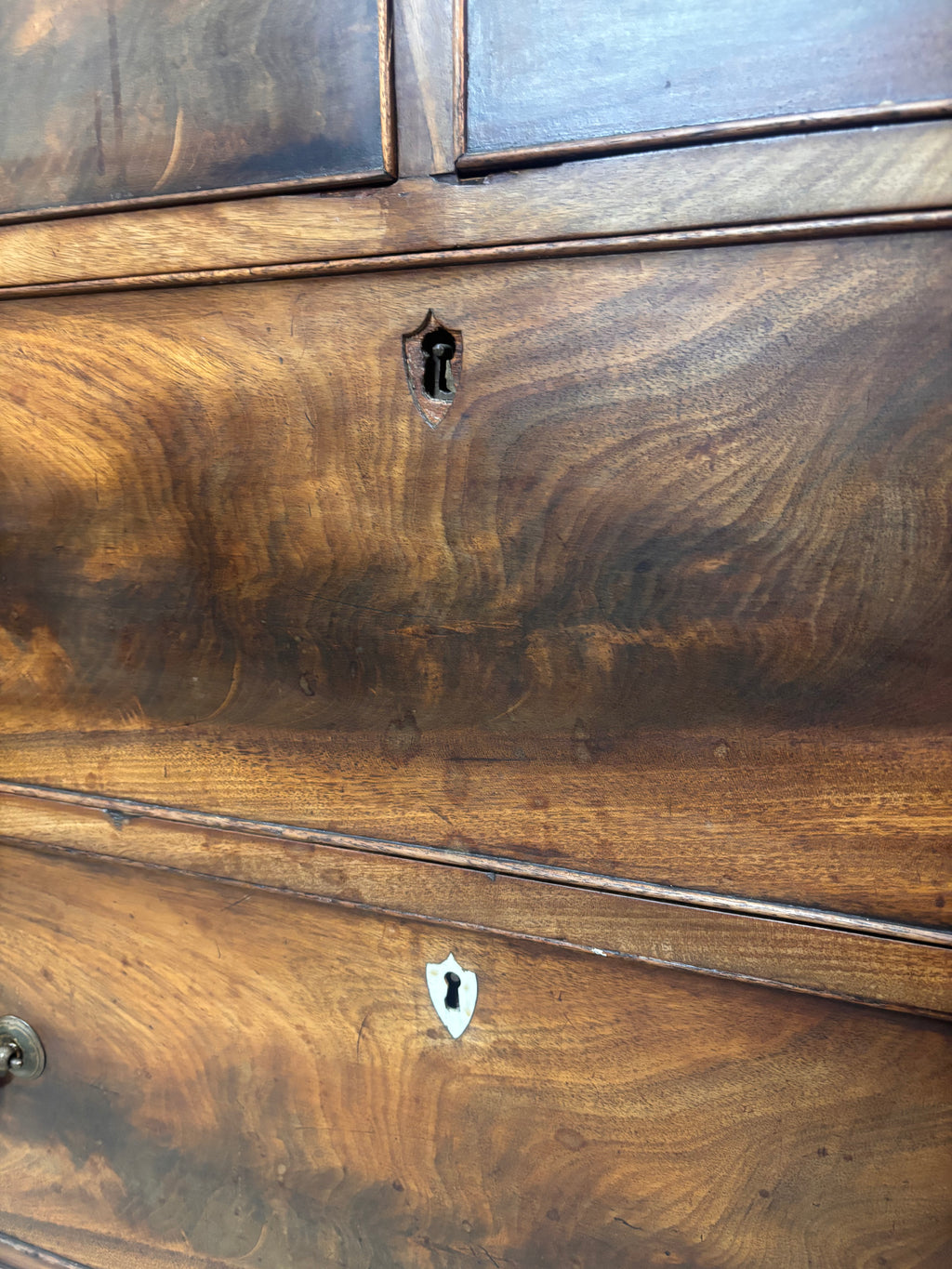 Close-up of a wooden dresser with visible grain and texture