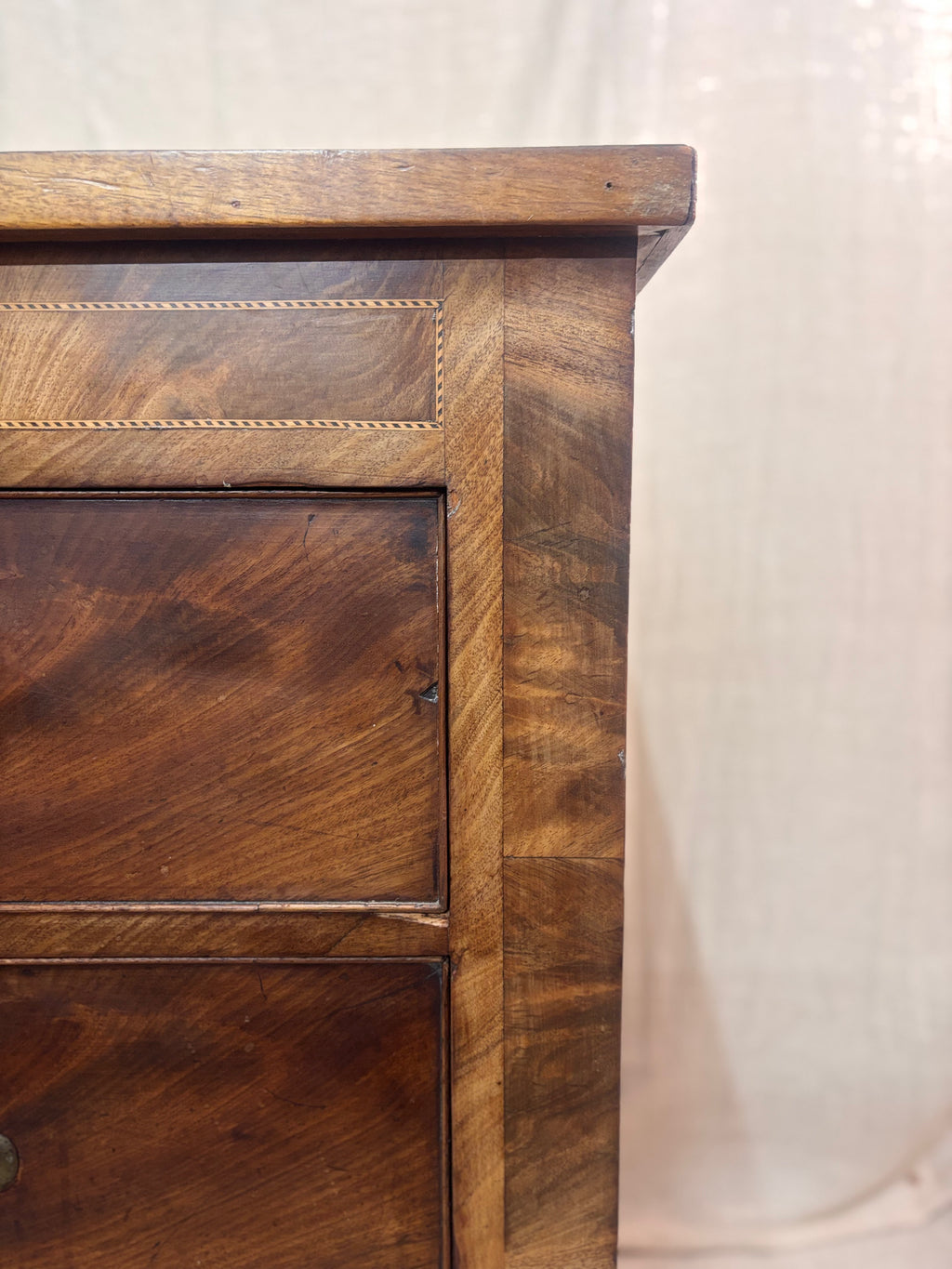Close-up of a wooden drawer with a plain background
