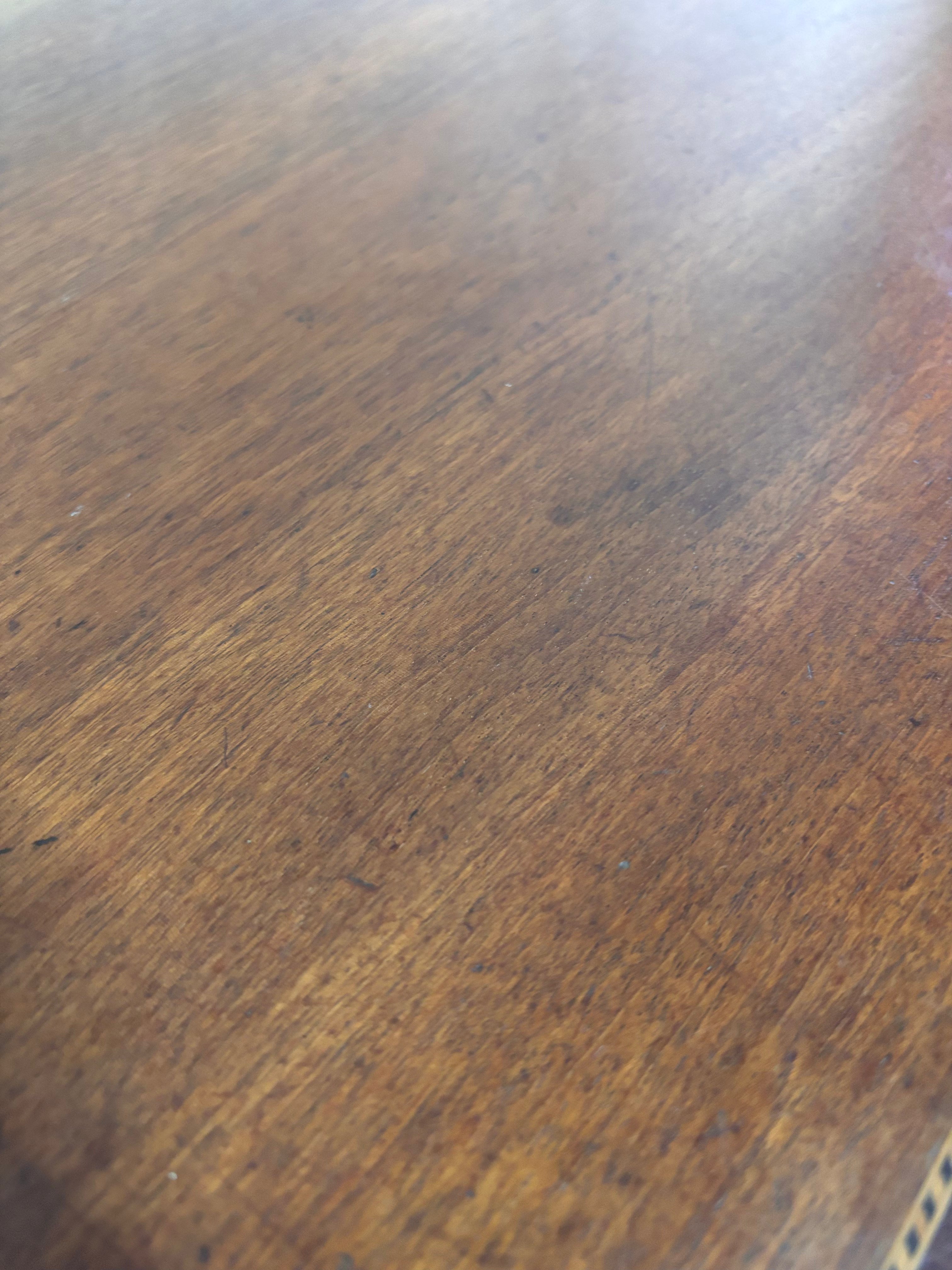 Close-up of a wooden surface with visible grain and texture.