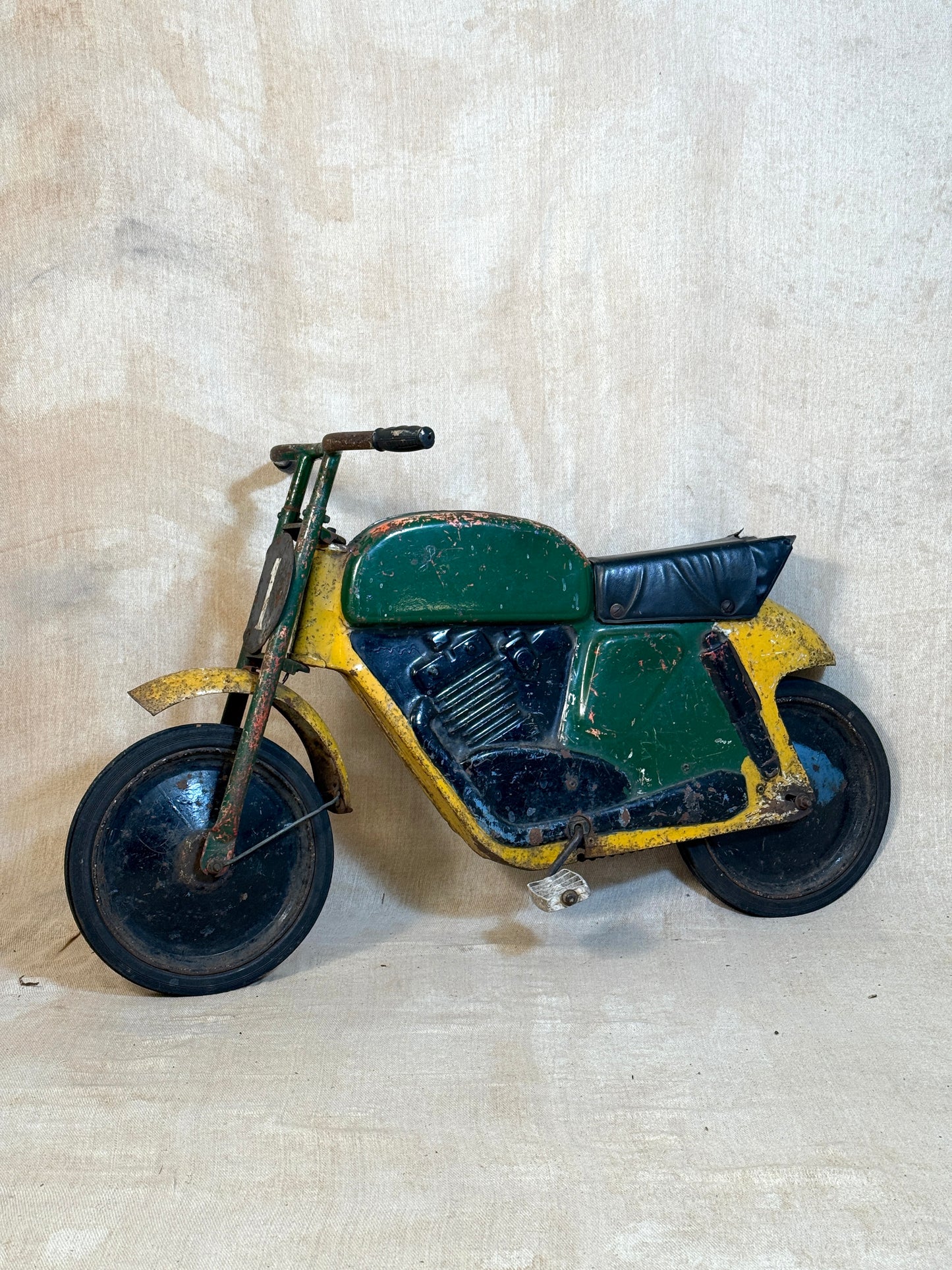 Mobo pressed steel pedal Motorcycle with yellow and green distressed paint. 