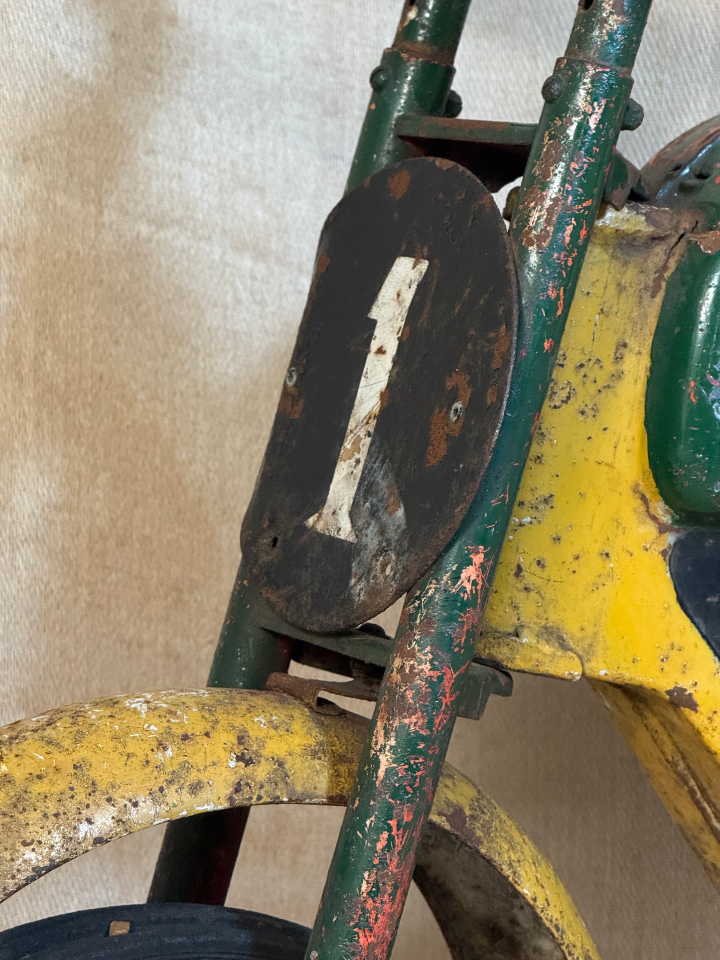 Mobo pressed steel pedal Motorcycle with yellow and green distressed paint. 