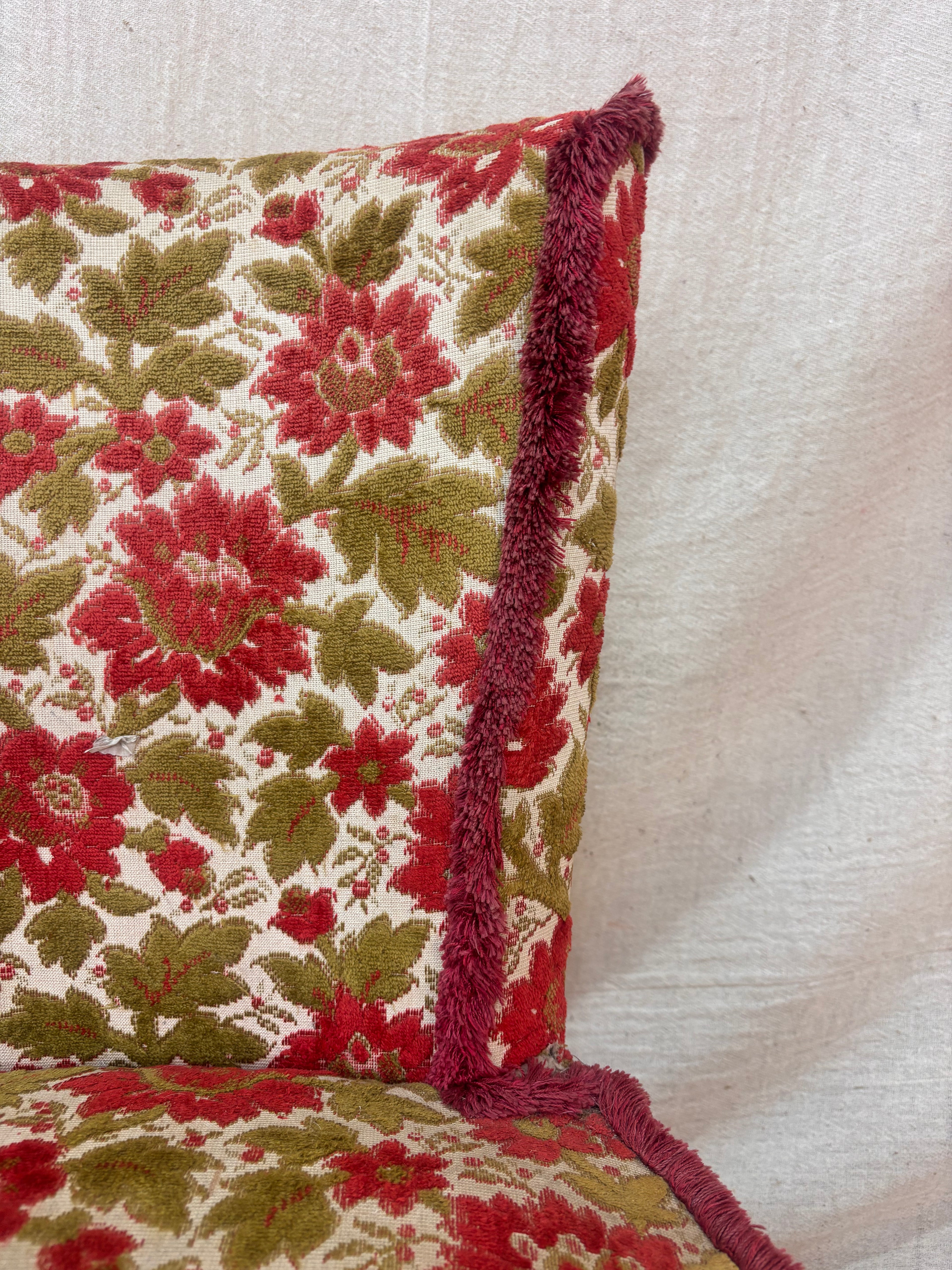 Floral patterned chair with red and green colours on a beige background