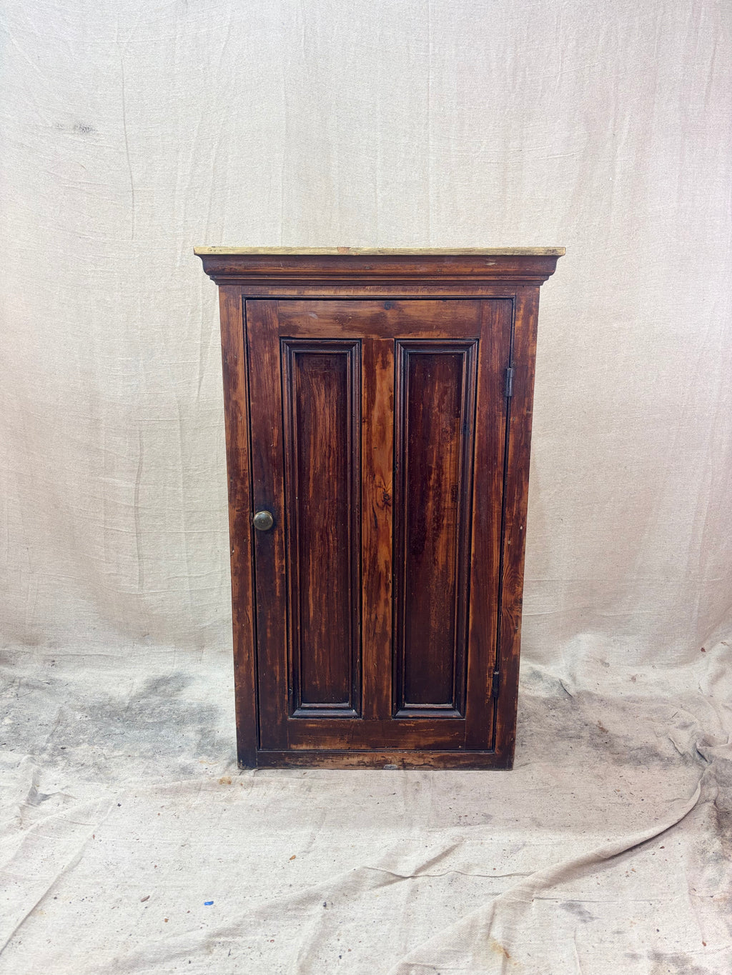 Wooden cabinet with a textured white background
