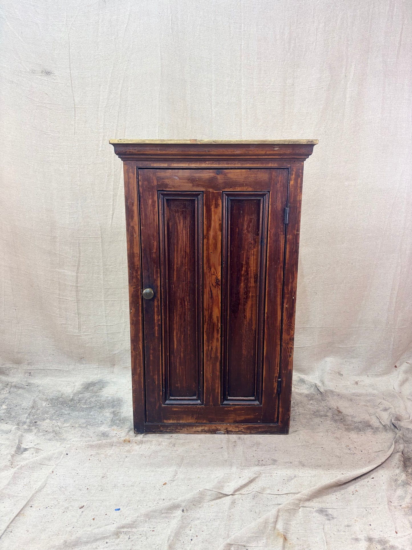 Wooden cabinet with a textured white background