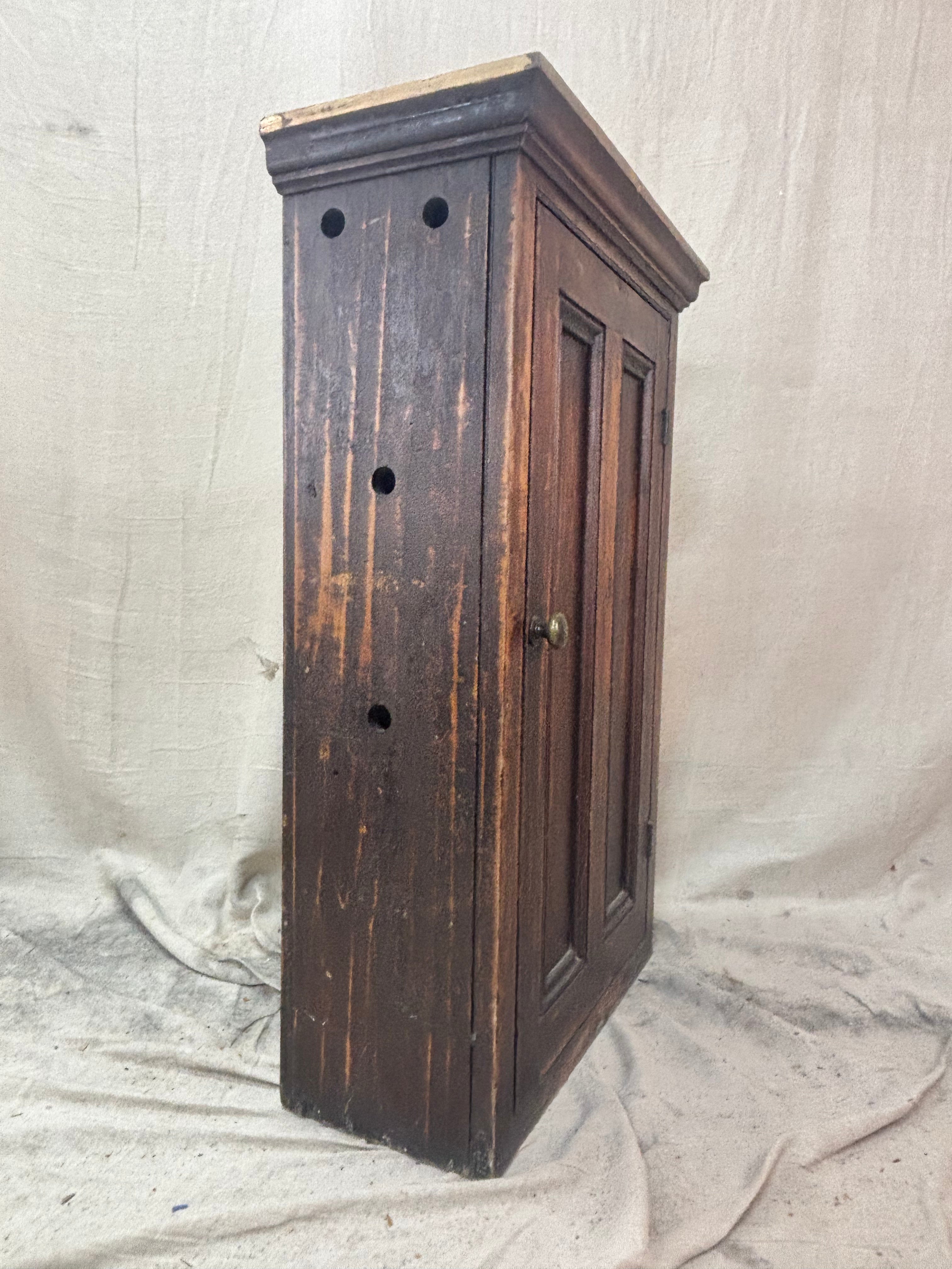 Wooden cabinet with a distressed finish on a plain background