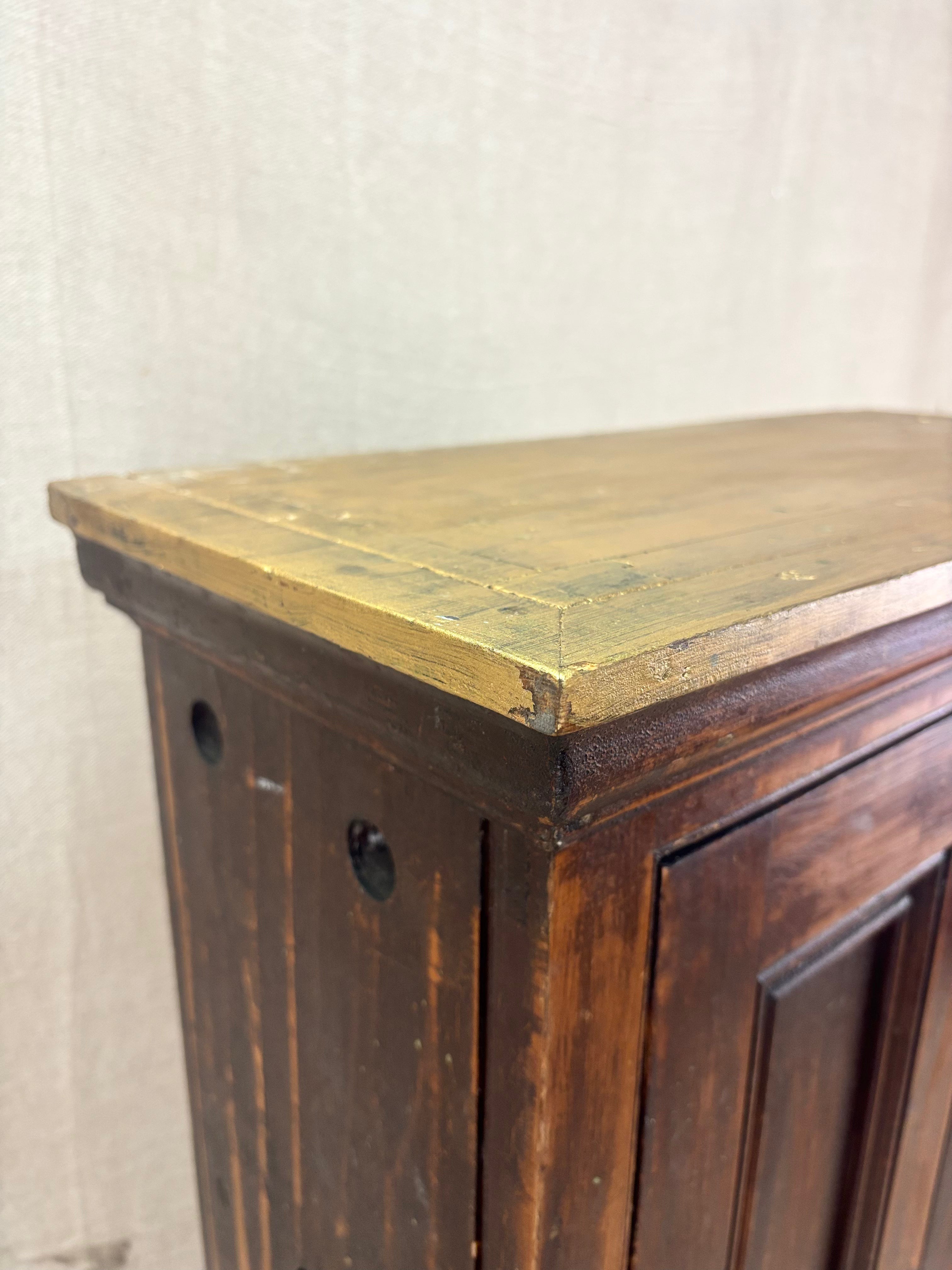 Wooden cabinet with a worn finish on a light background