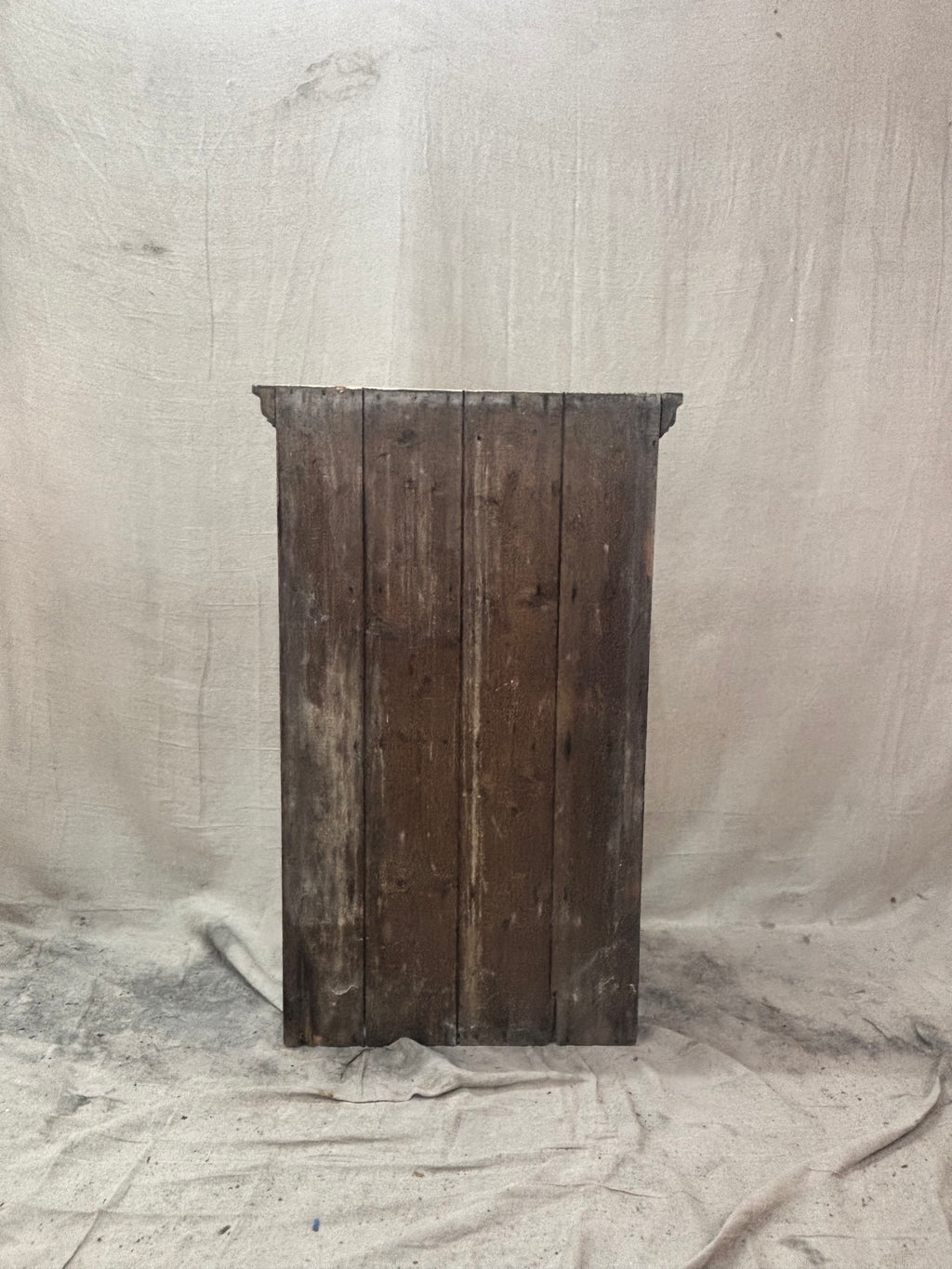 Vintage wooden cupboard against a textured beige background