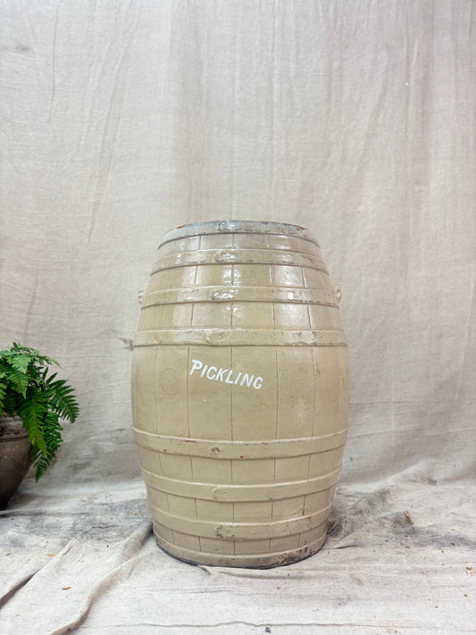 Stoneware barrel labeled 'PICKLING' on a textured fabric background