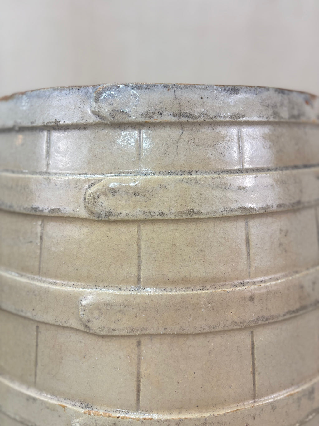 Close-up of a stoneware barrel with faux coppering detail.