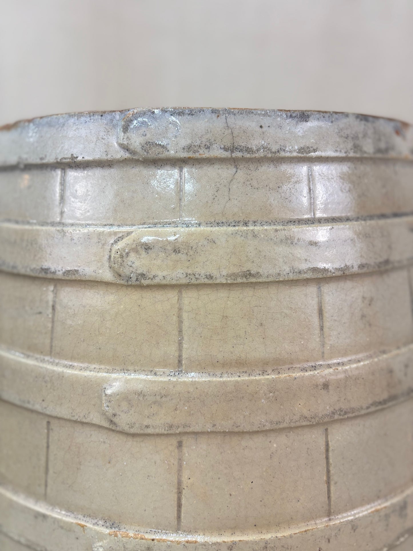 Close-up of a stoneware barrel with faux coppering detail.