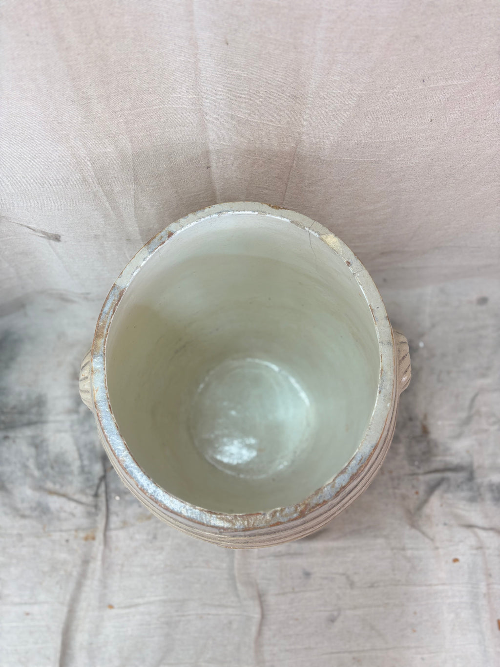 Large stoneware barrel on a beige fabric background