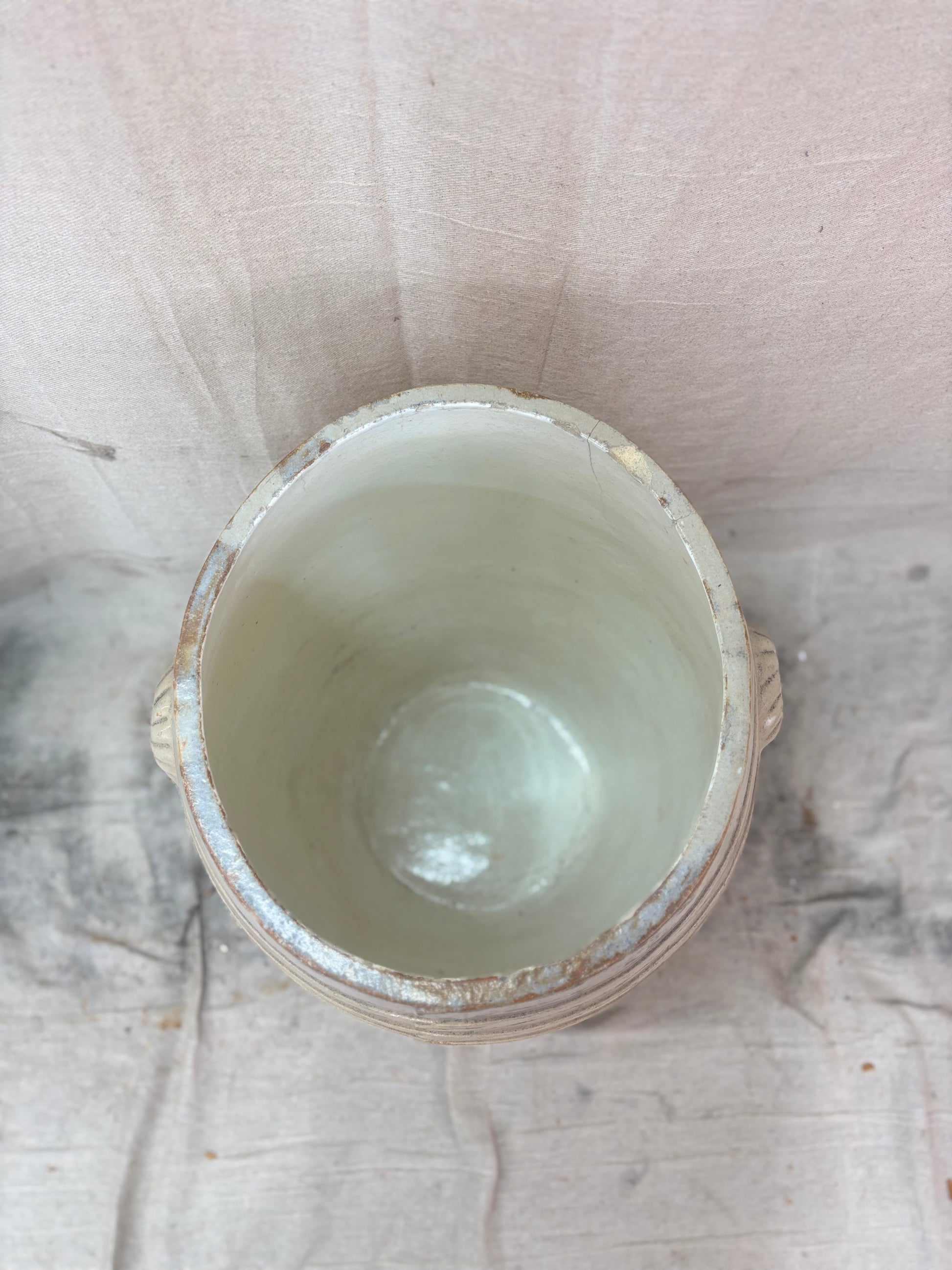 Large stoneware barrel on a beige fabric background