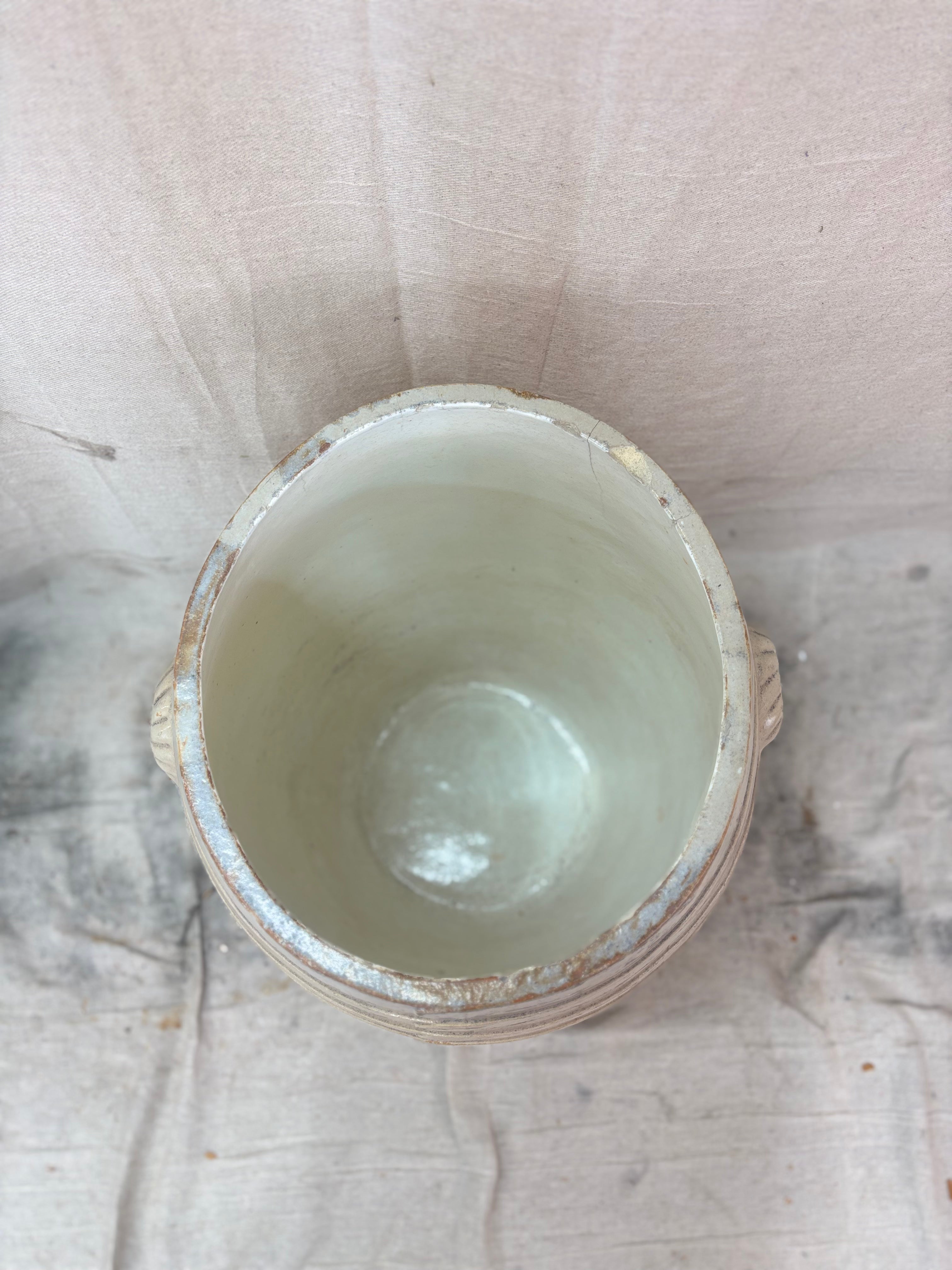 Large stoneware barrel on a beige fabric background