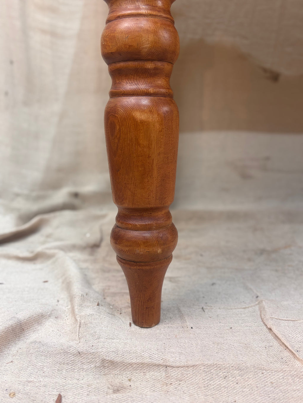 A chunky turned pine table leg