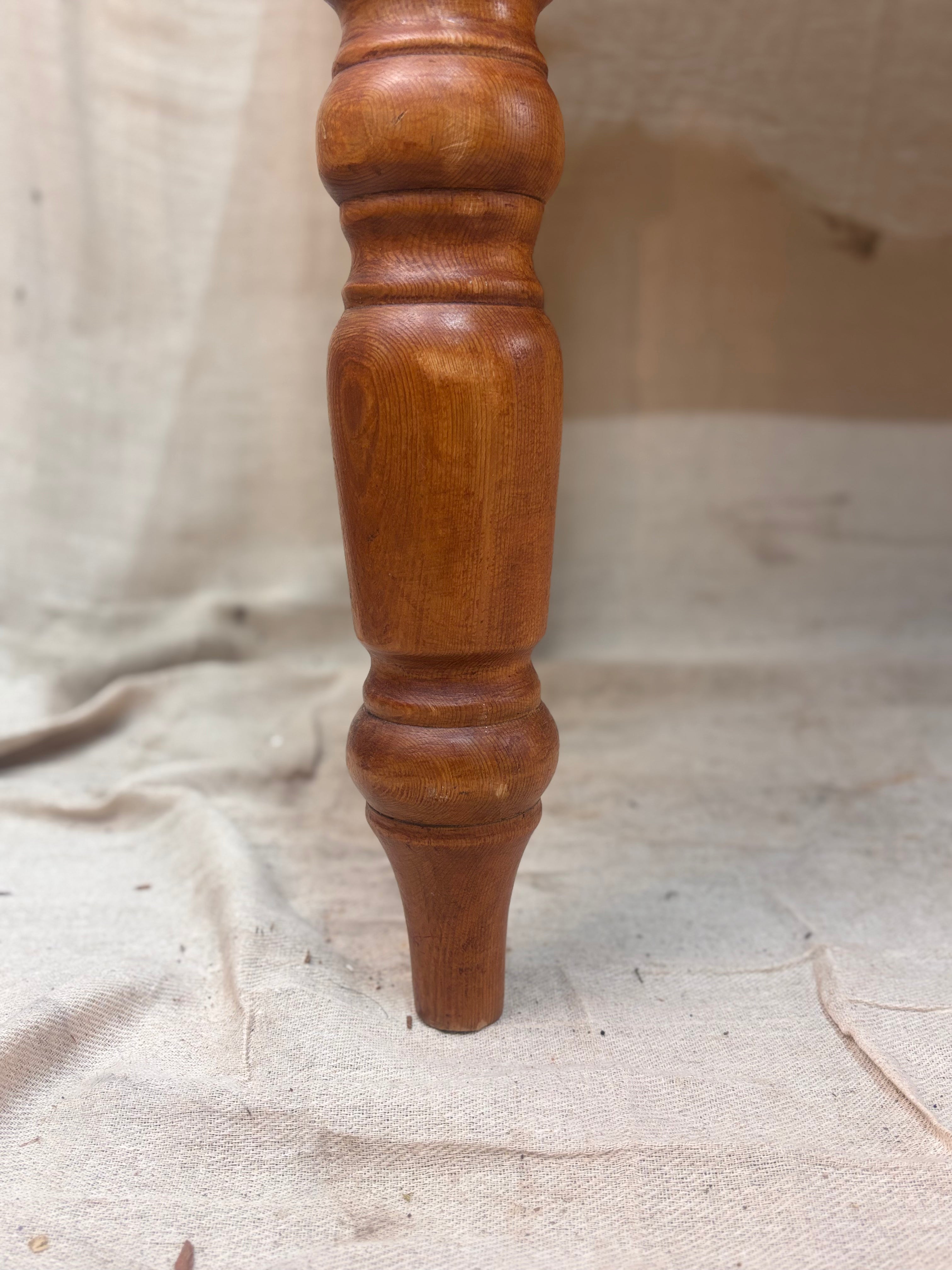 A chunky turned pine table leg