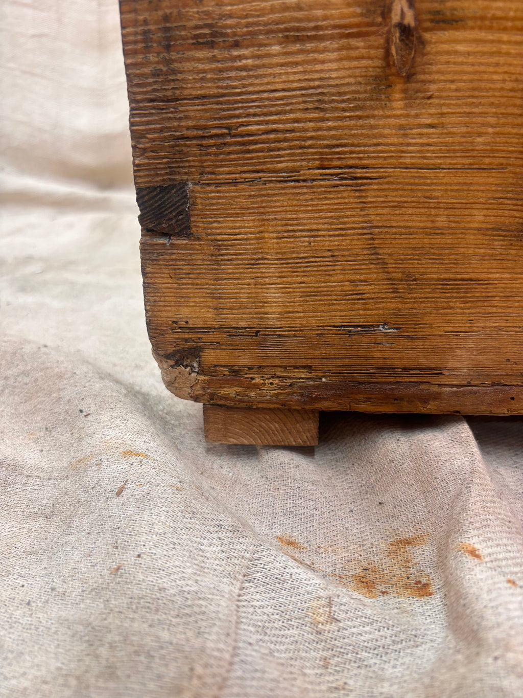 Close-up of a wooden block on a textured fabric background