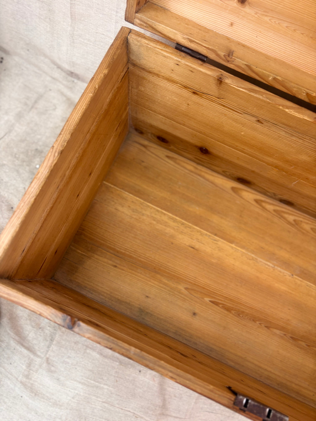 Wooden box with a lid on a textured surface