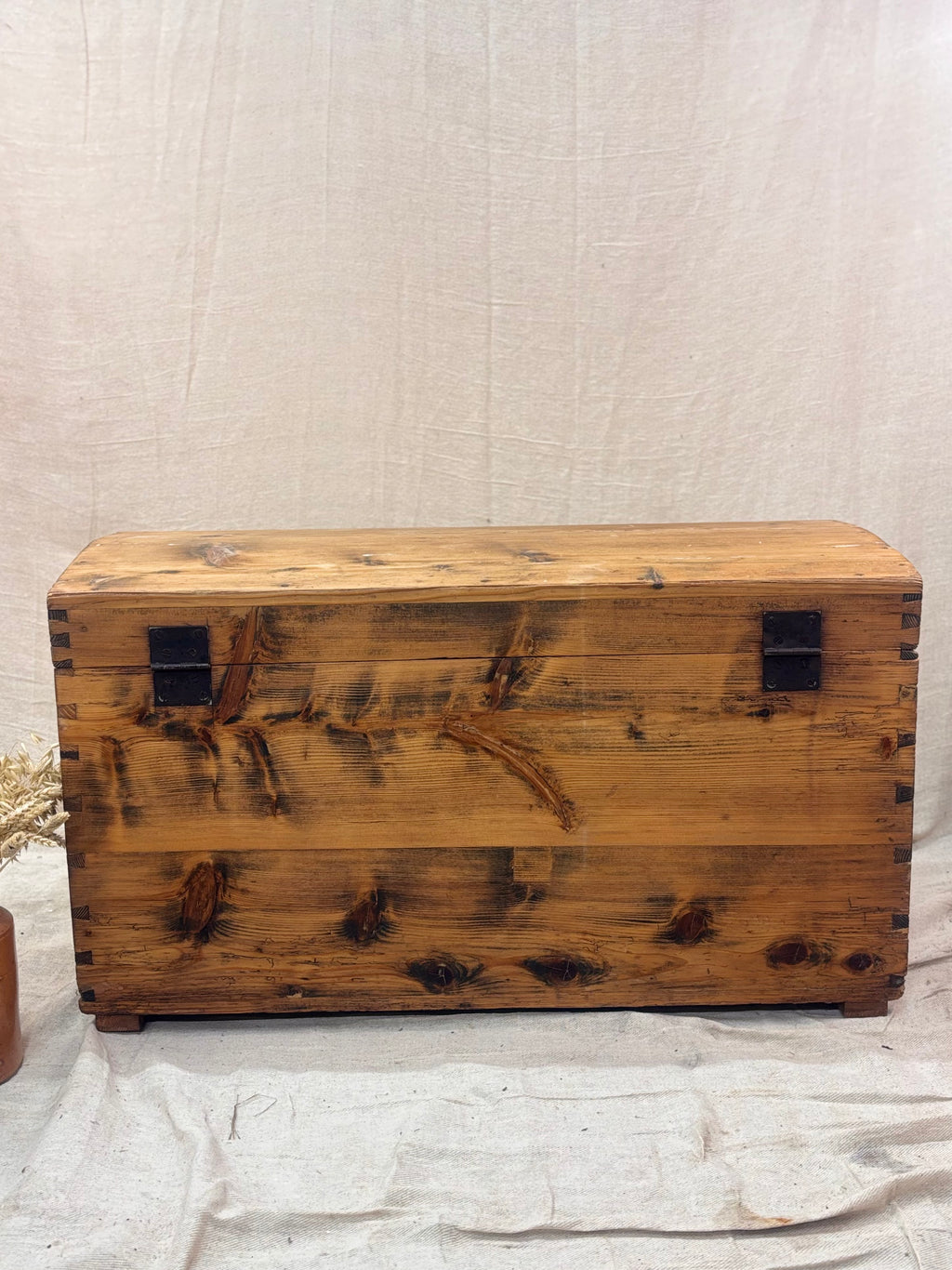 Wooden chest with a rustic finish on a light background