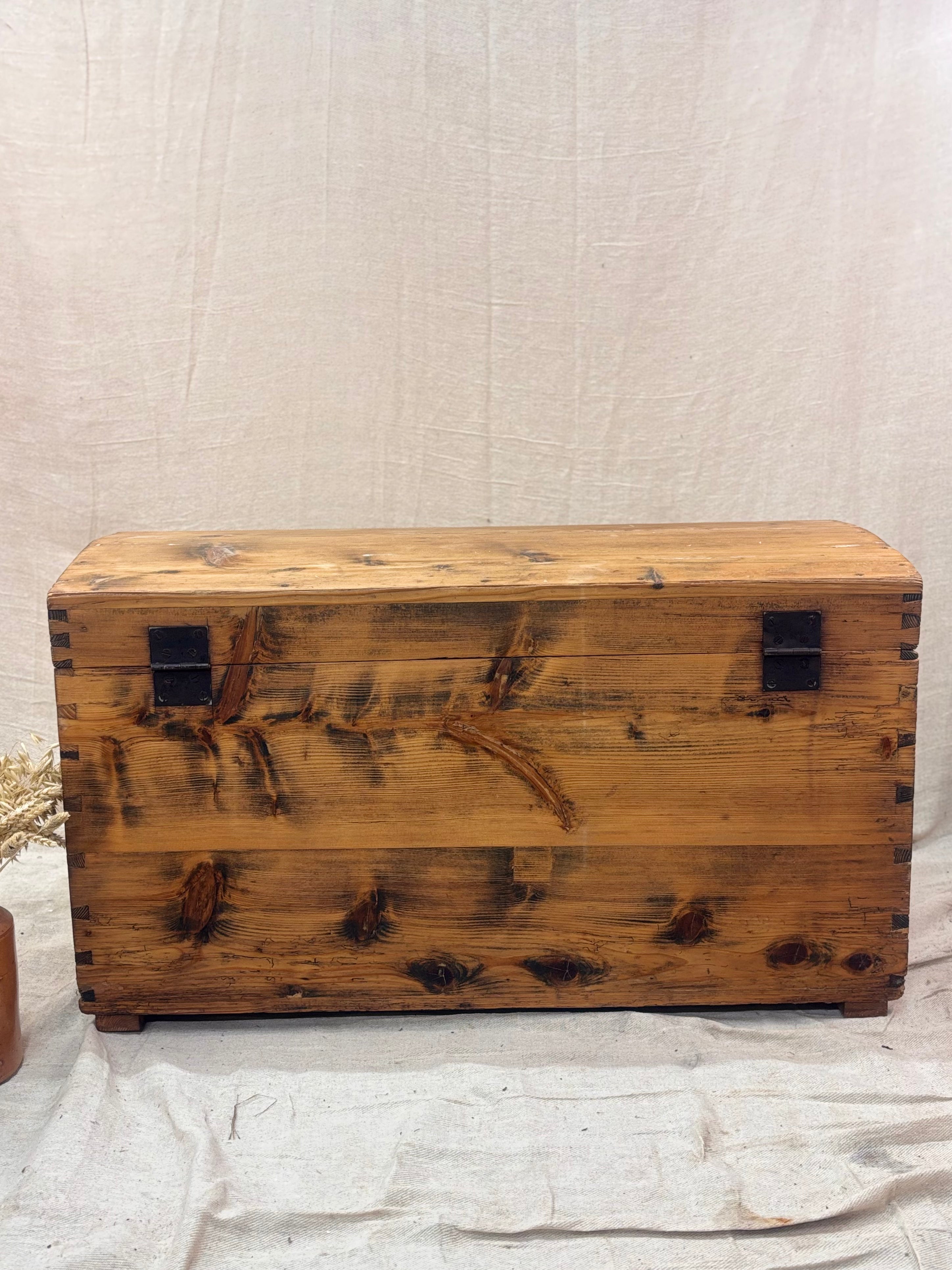 Wooden chest with a rustic finish on a light background