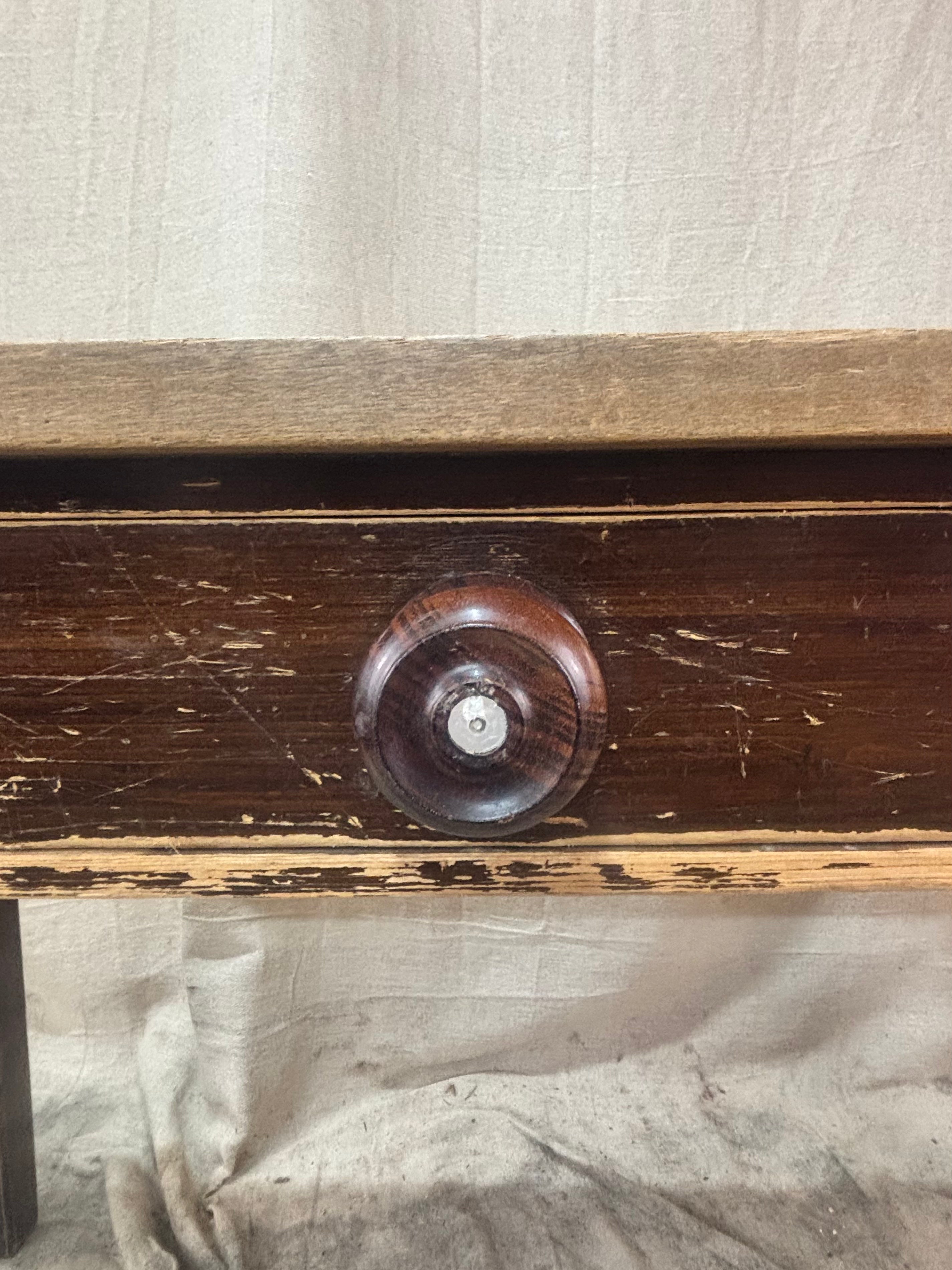 Close-up of a wooden drawer with a knob on a textured fabric background
