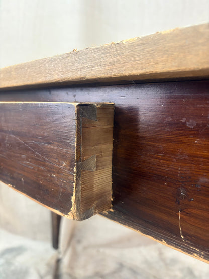 Close-up of a wooden furniture corner with visible grain and texture.