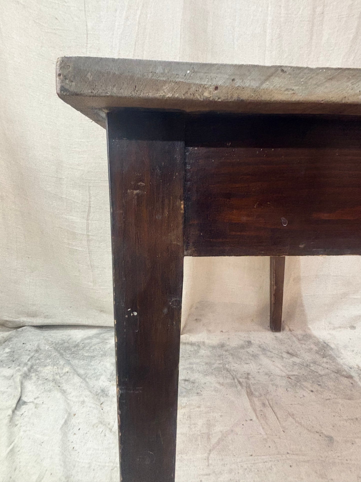 Wooden table with a worn surface on a textured white background