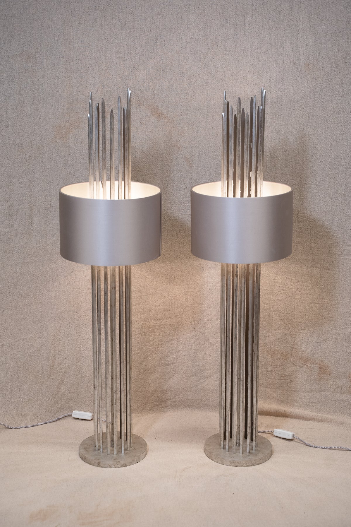 Pair of Porta Romana Flynn Caged Lamps in Decayed Silver, supplied with original cylinder shades. Used condition with minor shade creasing and surface scratches.