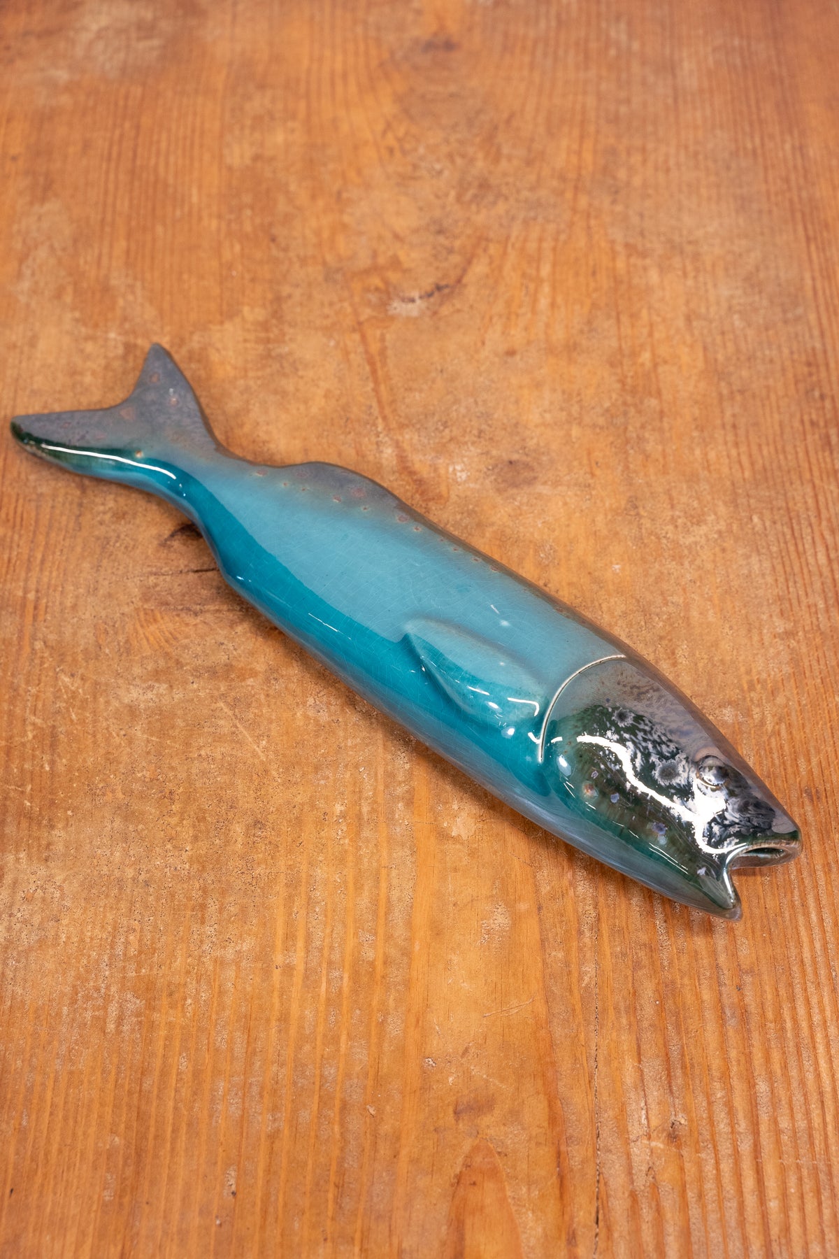 Hand-painted Portuguese ceramic sea bass wall decoration with unique surface details created using oxides and underglazes. Ideal for coastal interiors.