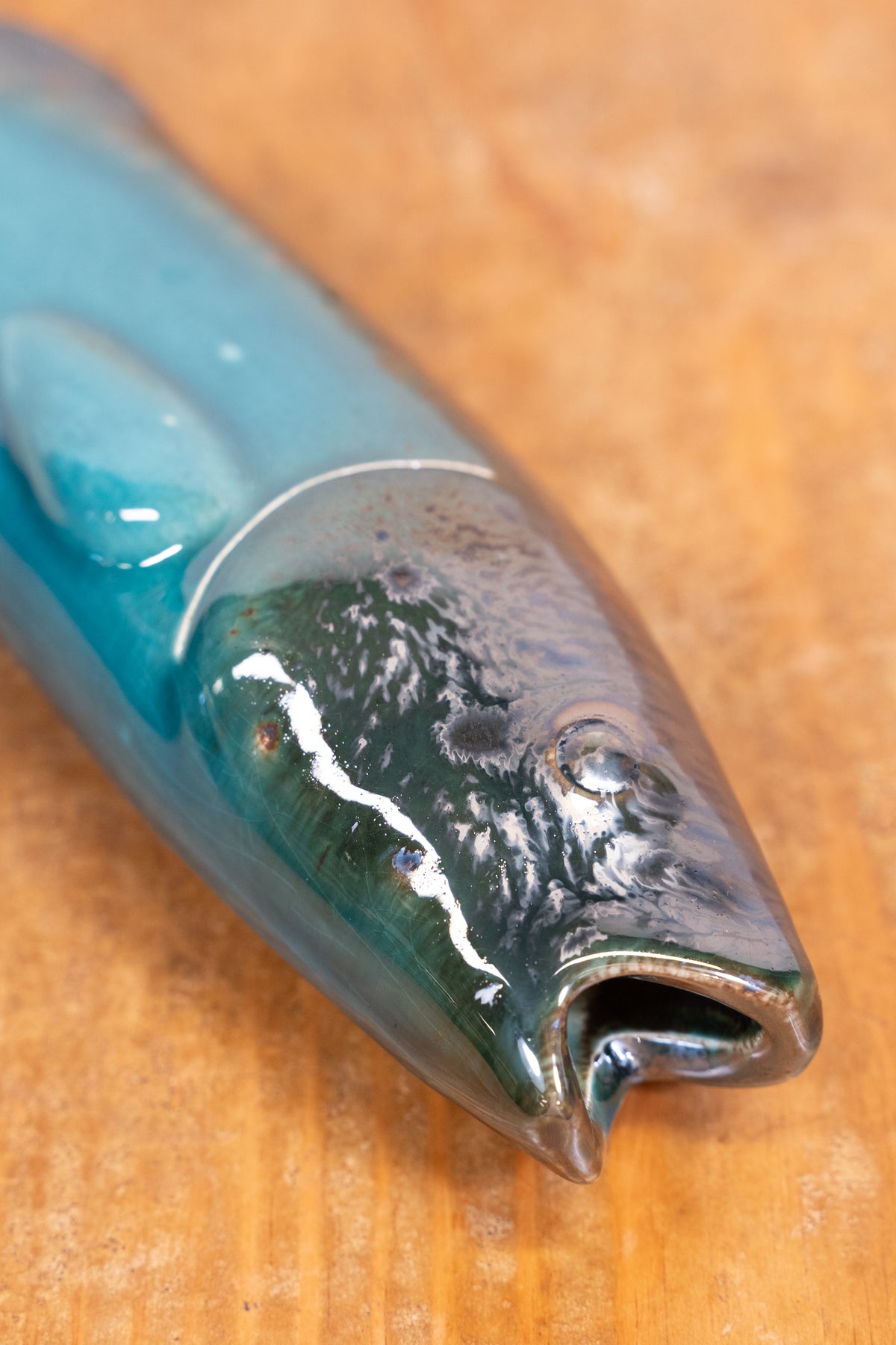 Hand-painted Portuguese ceramic sea bass wall decoration with unique surface details created using oxides and underglazes. Ideal for coastal interiors.