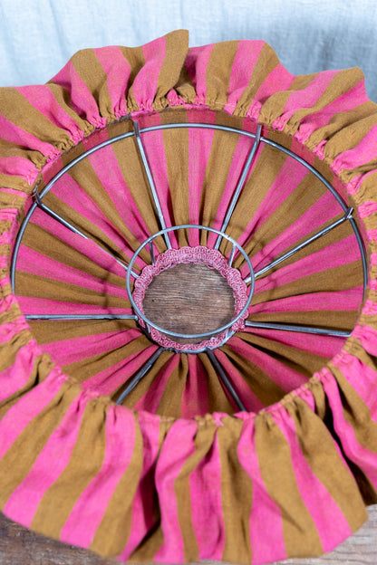 Handmade 12-inch linen carousel shade with raspberry and ochre stripes, vintage trim and pendant fitting. Cosy cottage style.
