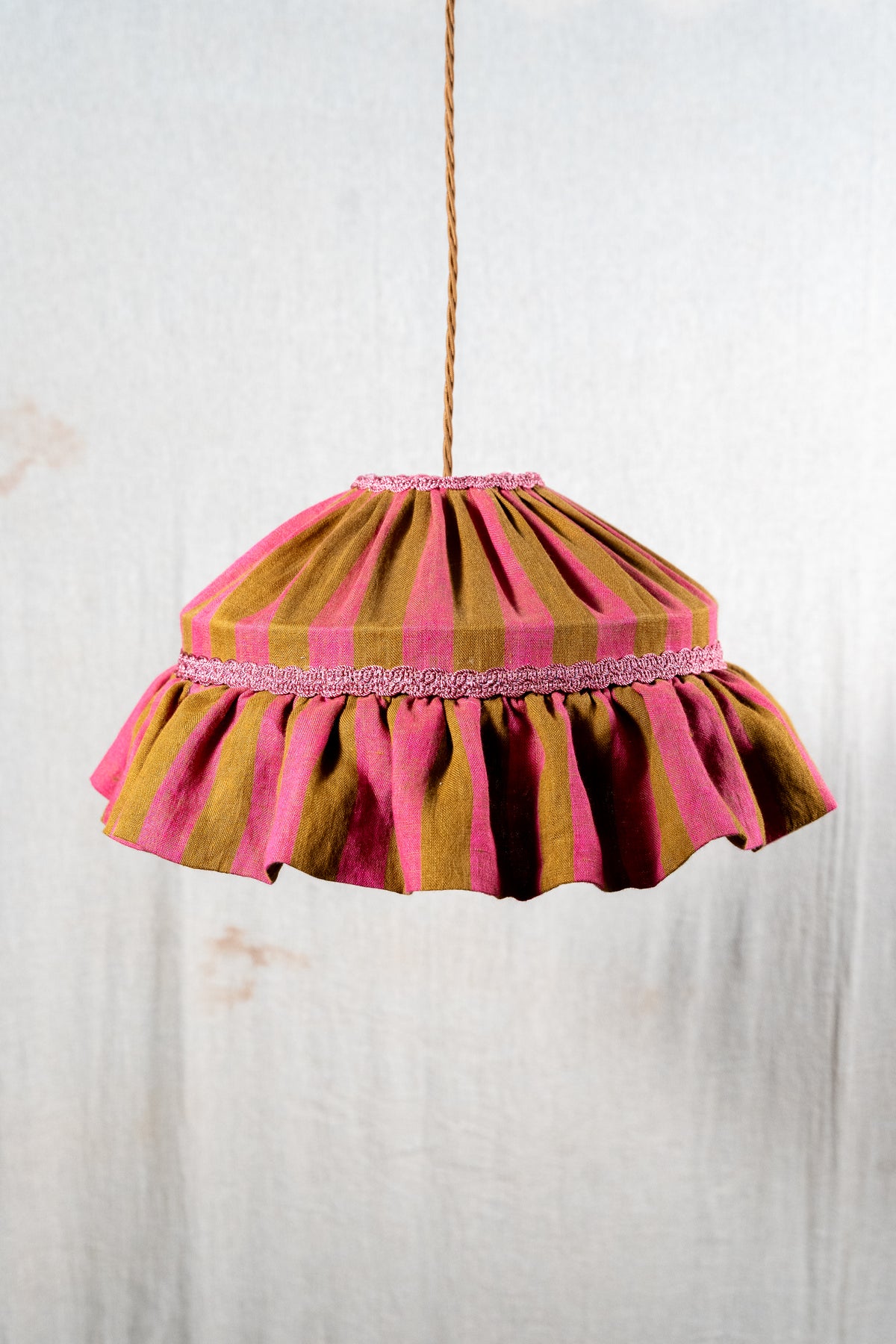 Handmade 12-inch linen carousel shade with raspberry and ochre stripes, vintage trim and pendant fitting. Cosy cottage style.