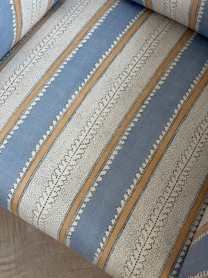 Refurbished antique armchair upholstered in Linwood Dimity ‘Powder Blue’, with a high back, side wings, dark wooden legs and brass casters.