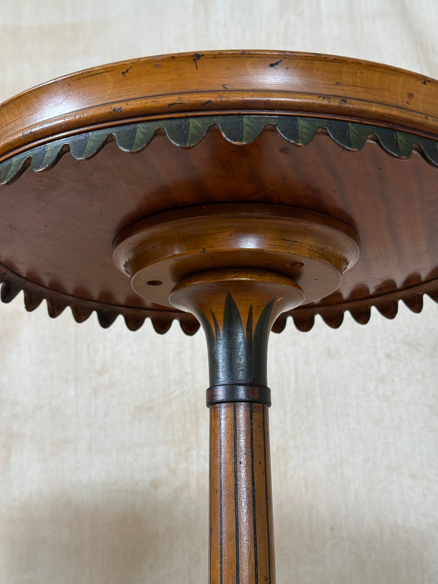 Two ornate dark brown Torchere Stands with decorative scrollwork bases, shown against a draped beige fabric backdrop. 