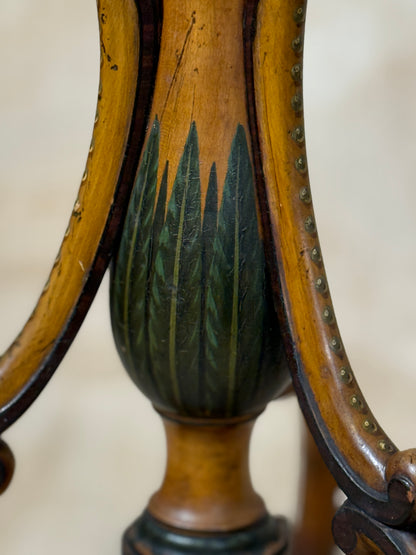 Two ornate dark brown Torchere Stands with decorative scrollwork bases, shown against a draped beige fabric backdrop. 
