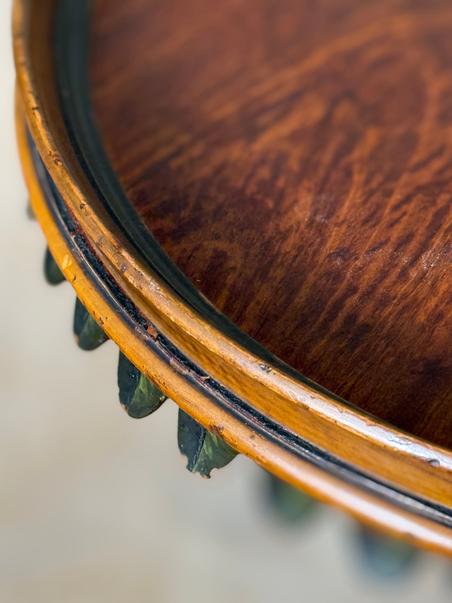 Two ornate dark brown Torchere Stands with decorative scrollwork bases, shown against a draped beige fabric backdrop. 