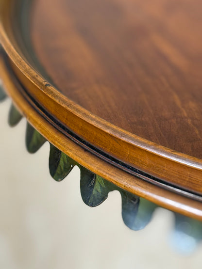 Two ornate dark brown Torchere Stands with decorative scrollwork bases, shown against a draped beige fabric backdrop. 