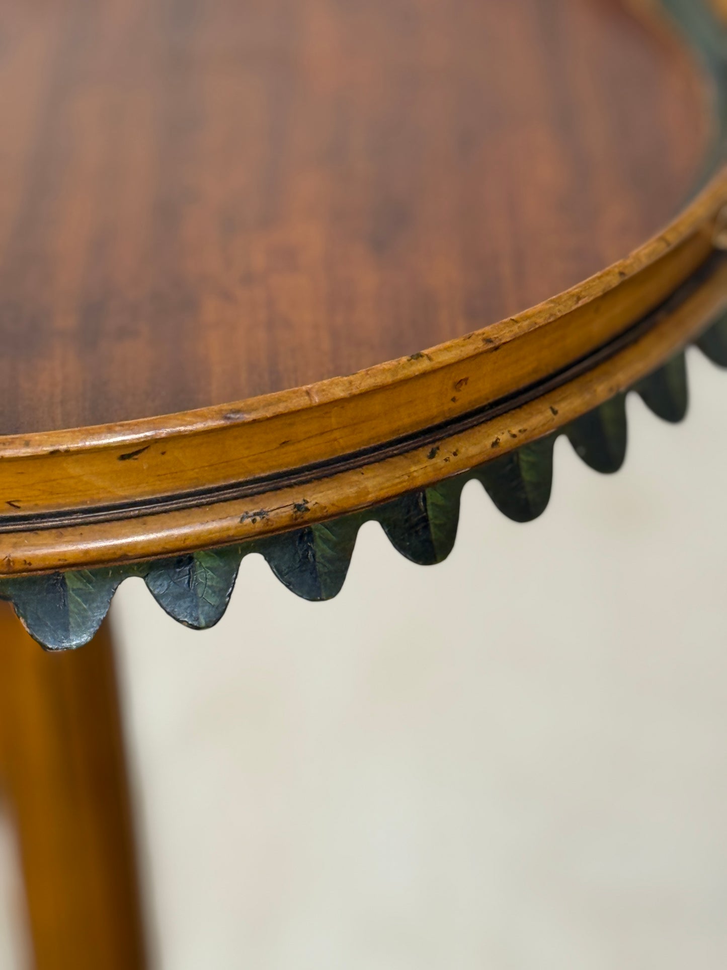 Two ornate dark brown Torchere Stands with decorative scrollwork bases, shown against a draped beige fabric backdrop. 