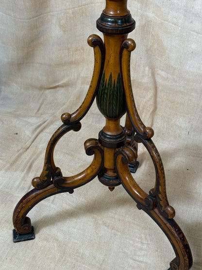 Two ornate dark brown Torchere Stands with decorative scrollwork bases, shown against a draped beige fabric backdrop. 