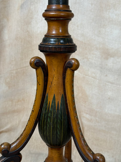 Two ornate dark brown Torchere Stands with decorative scrollwork bases, shown against a draped beige fabric backdrop. 