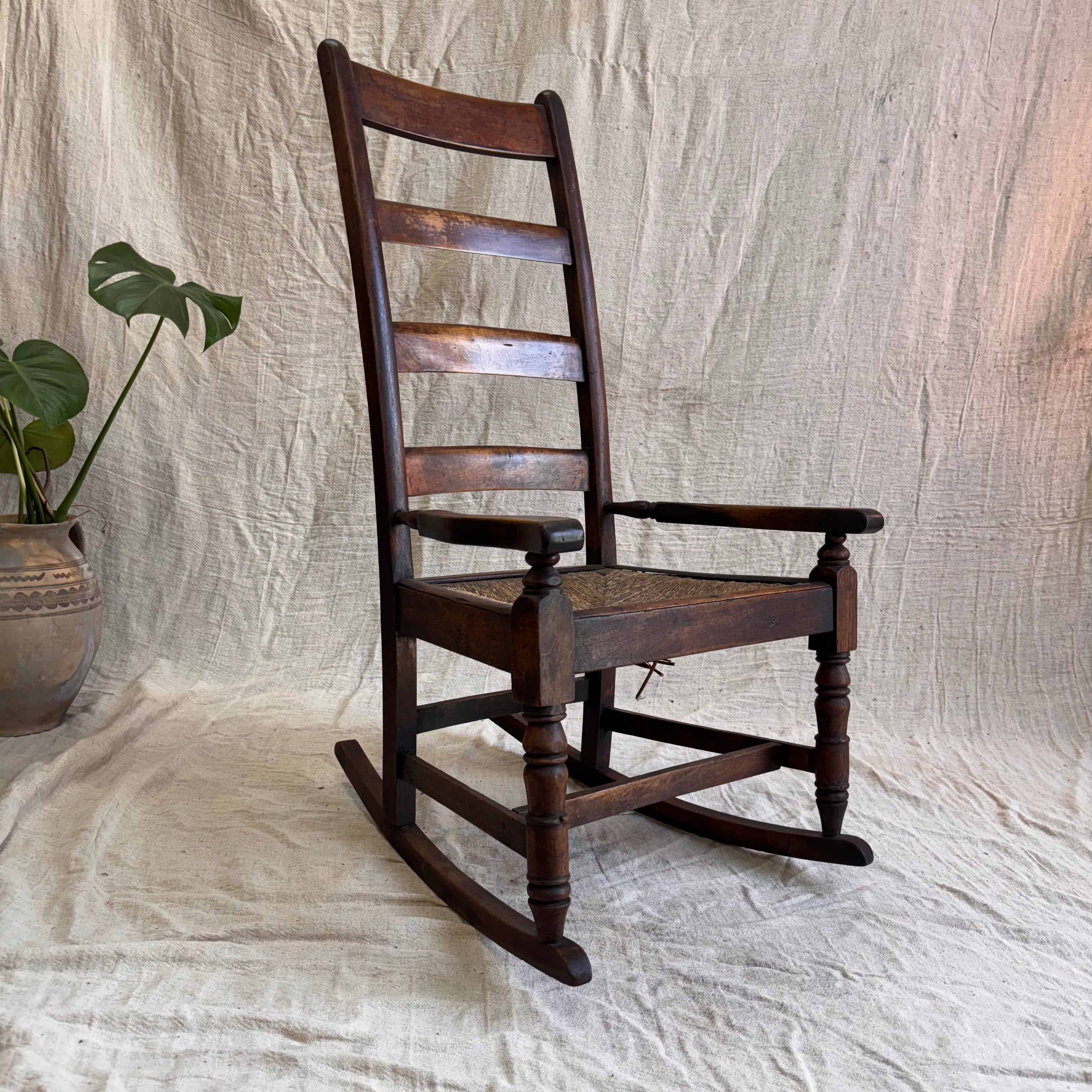 A wooden rocking chair on a cream background