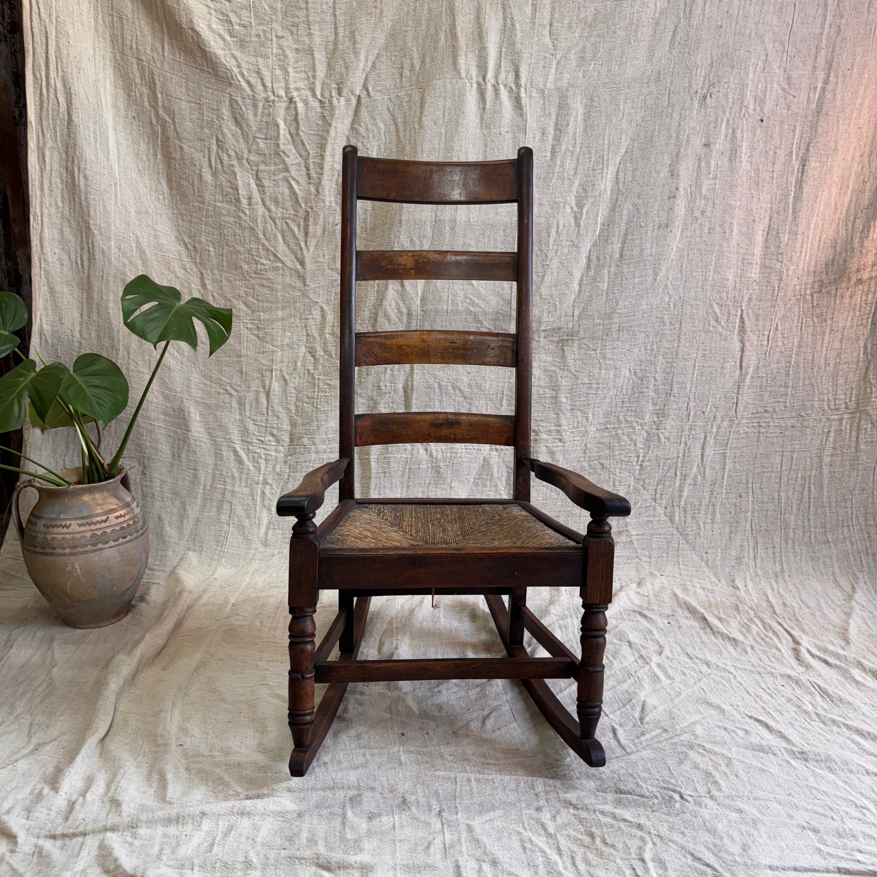 a wooden rocking chair on a cream background