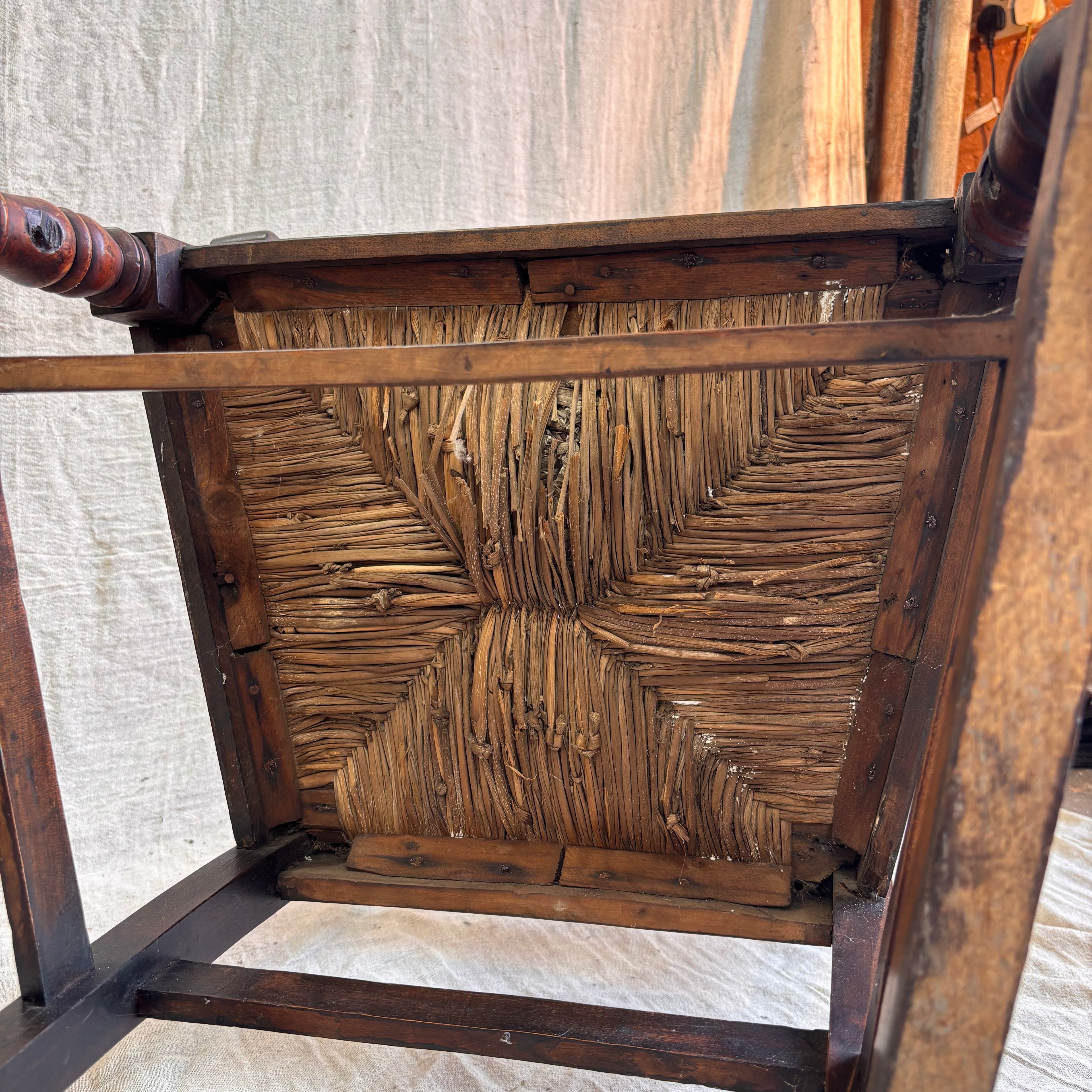 Close-up of a wooden chair with wicker seat and backrest.