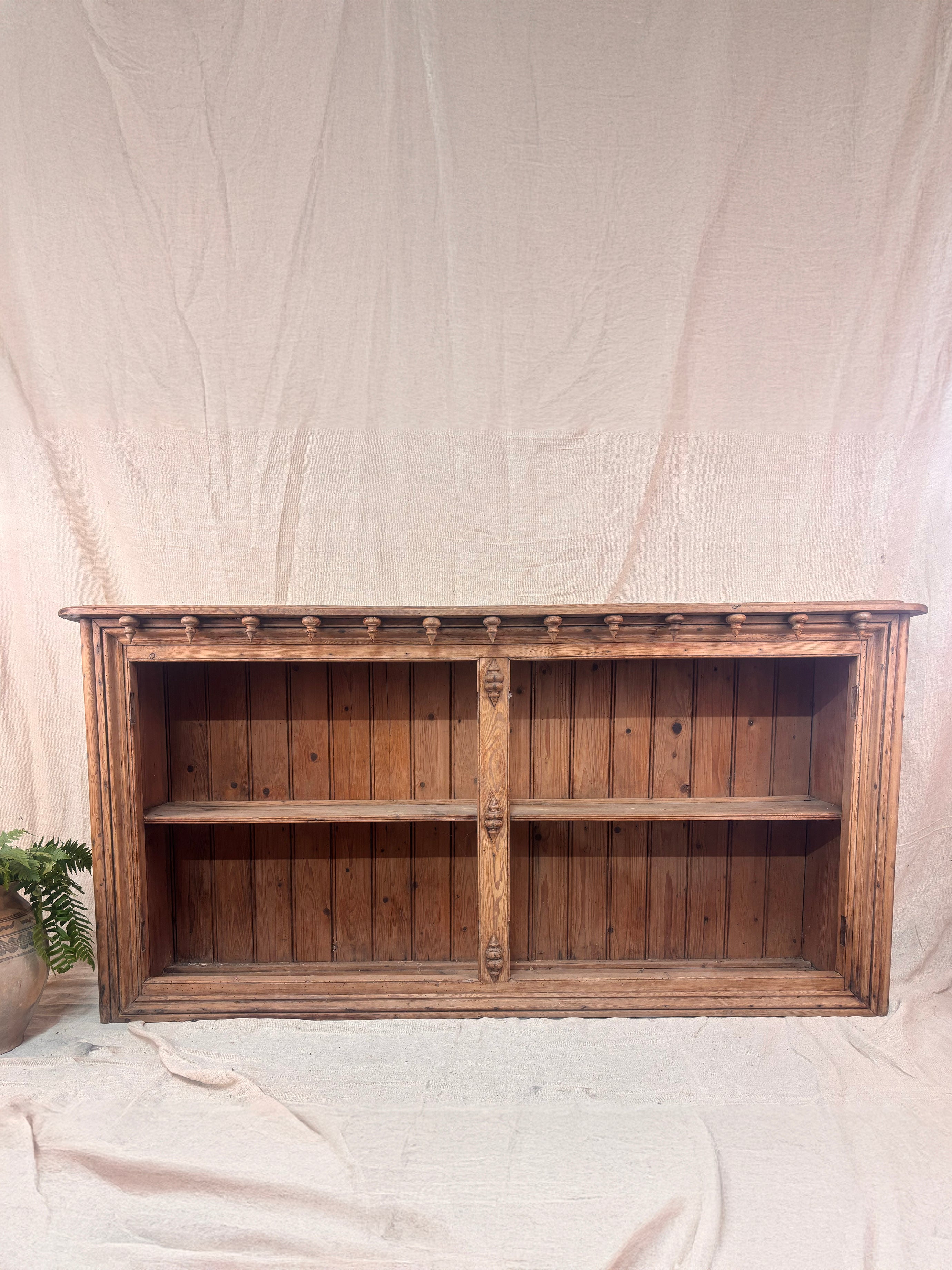 Wooden bookshelf against a plain white background