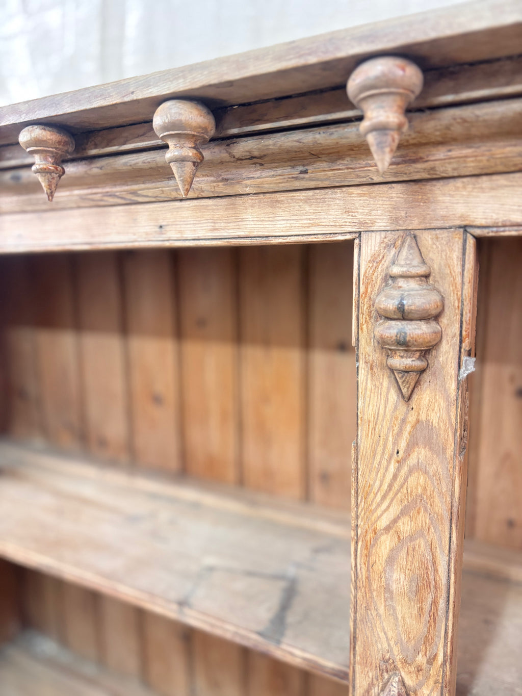Close-up of an old wooden shelf with decorative elements