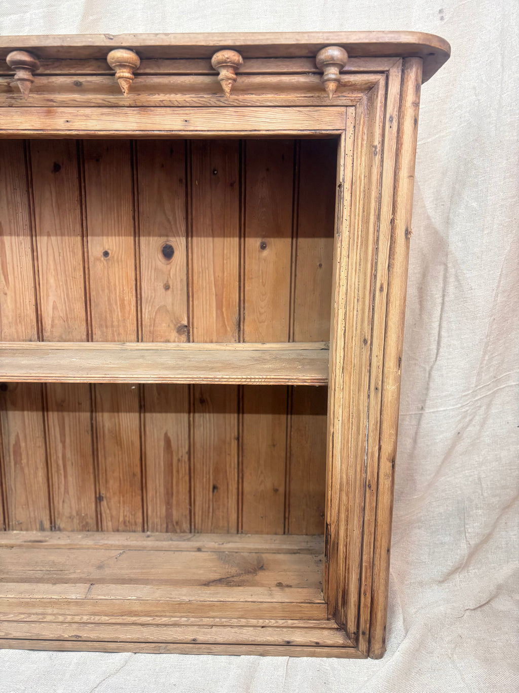 Wooden bookshelf with a plain background