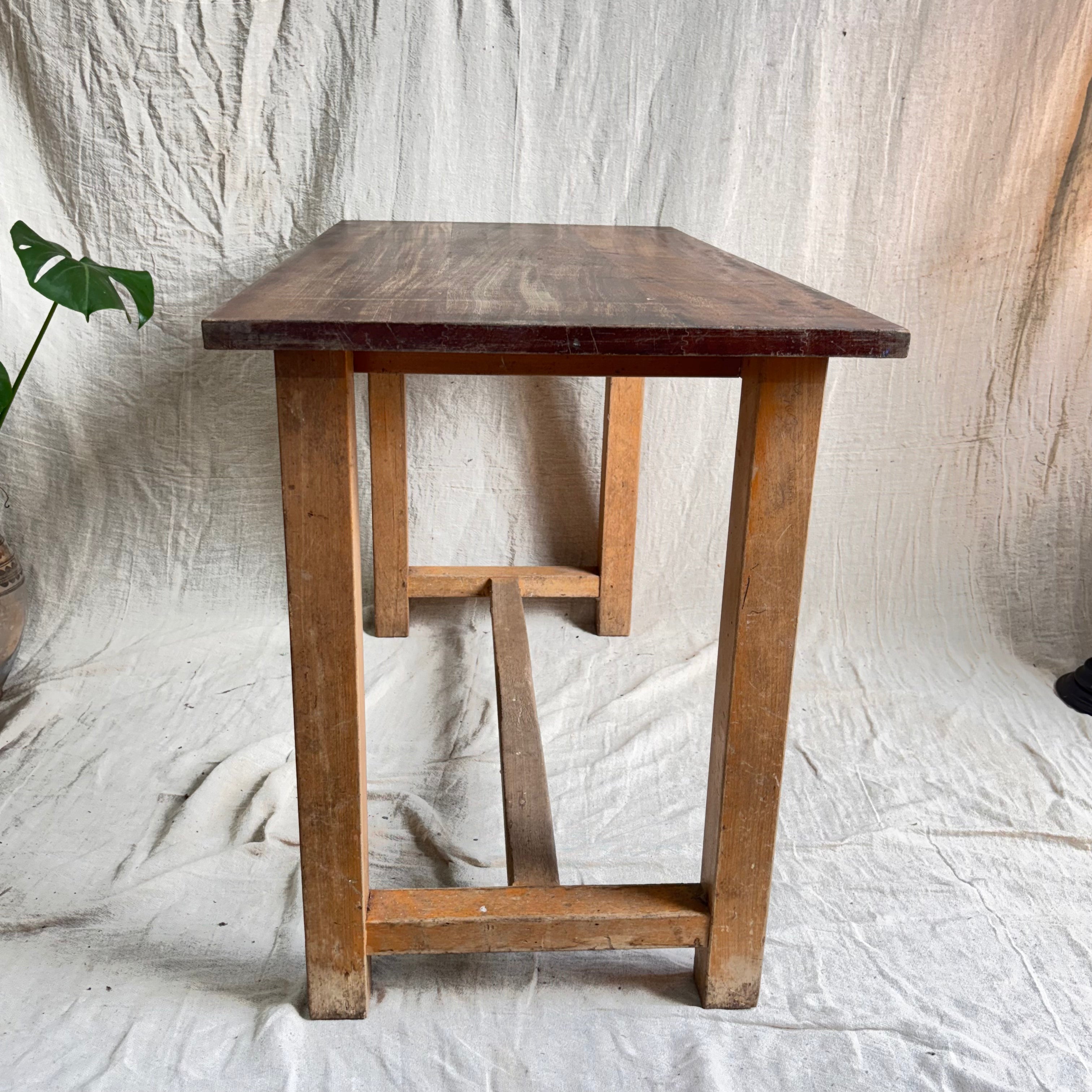 Wooden table with a rustic finish on a textured white background
