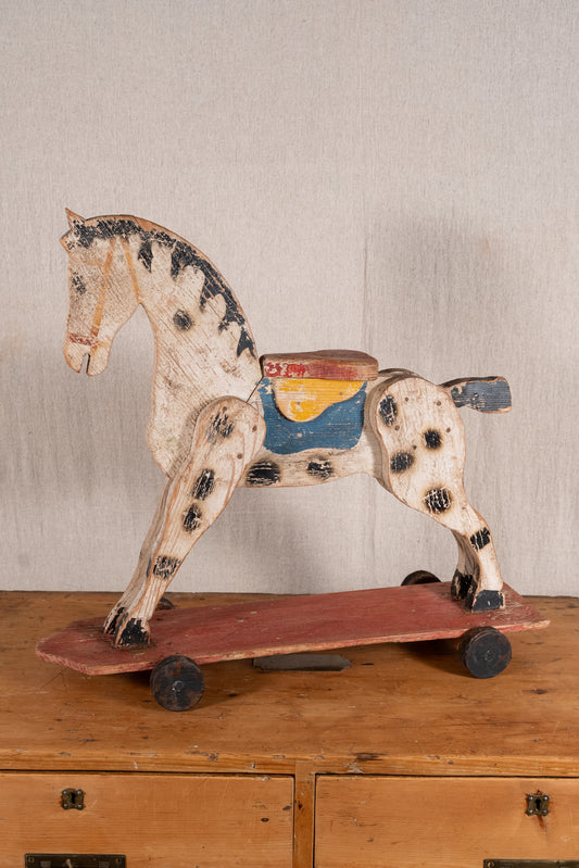 Vintage scratch-built wooden pull-along horse, possibly of French origin. A characterful folk-art toy for collectors or decorative display.