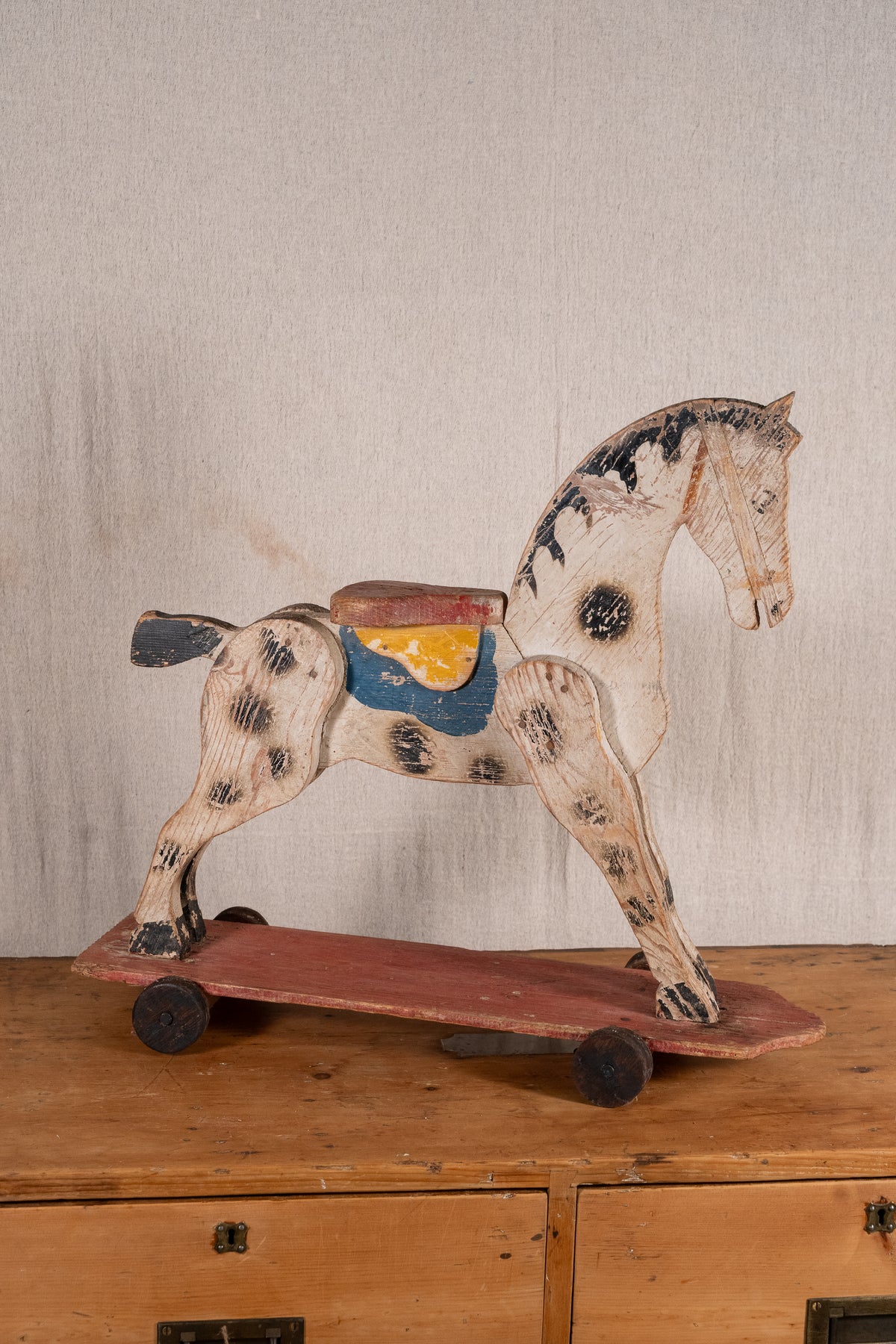 Vintage scratch-built wooden pull-along horse, possibly of French origin. A characterful folk-art toy for collectors or decorative display.