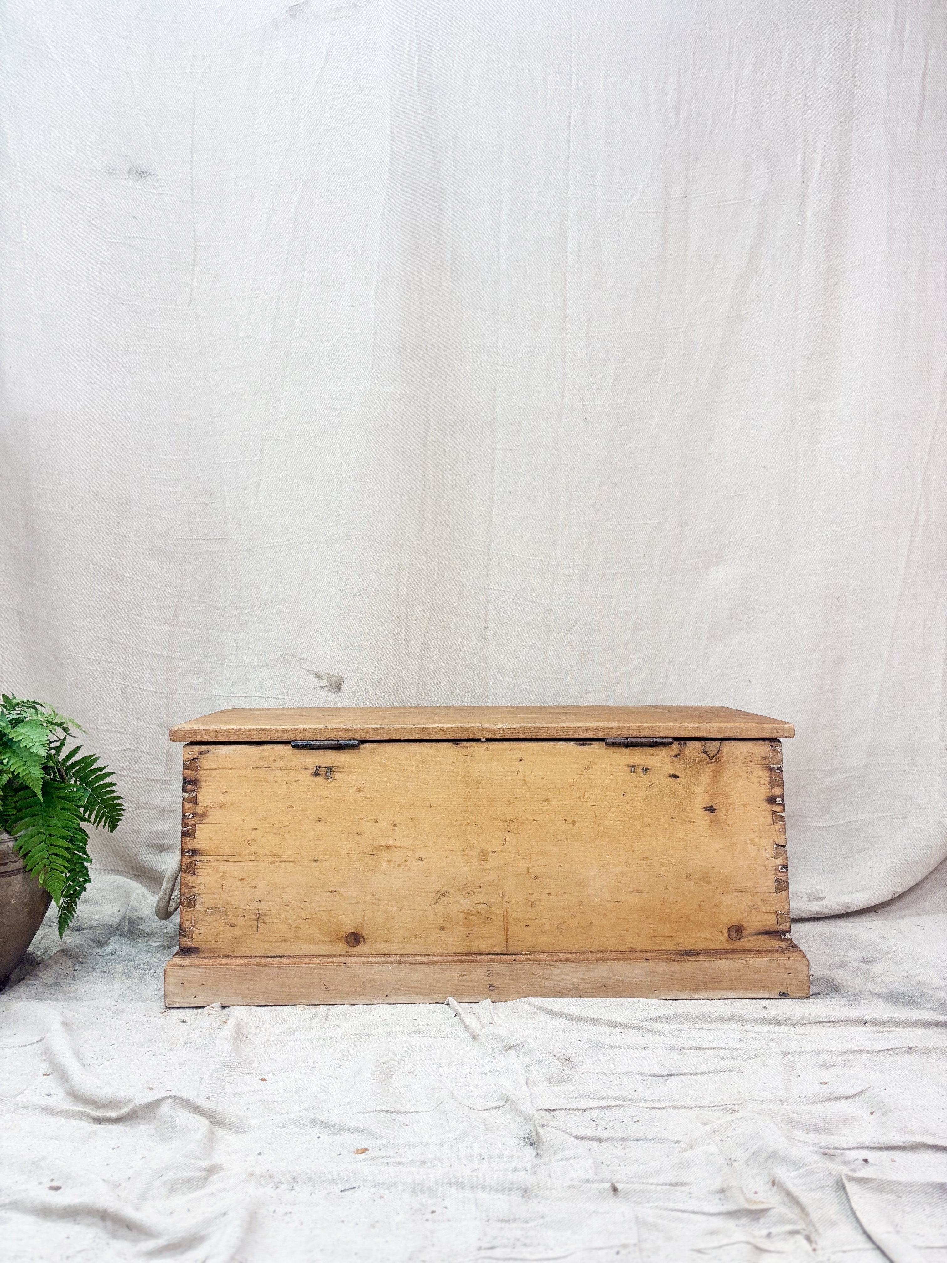 Wooden chest on a white fabric background